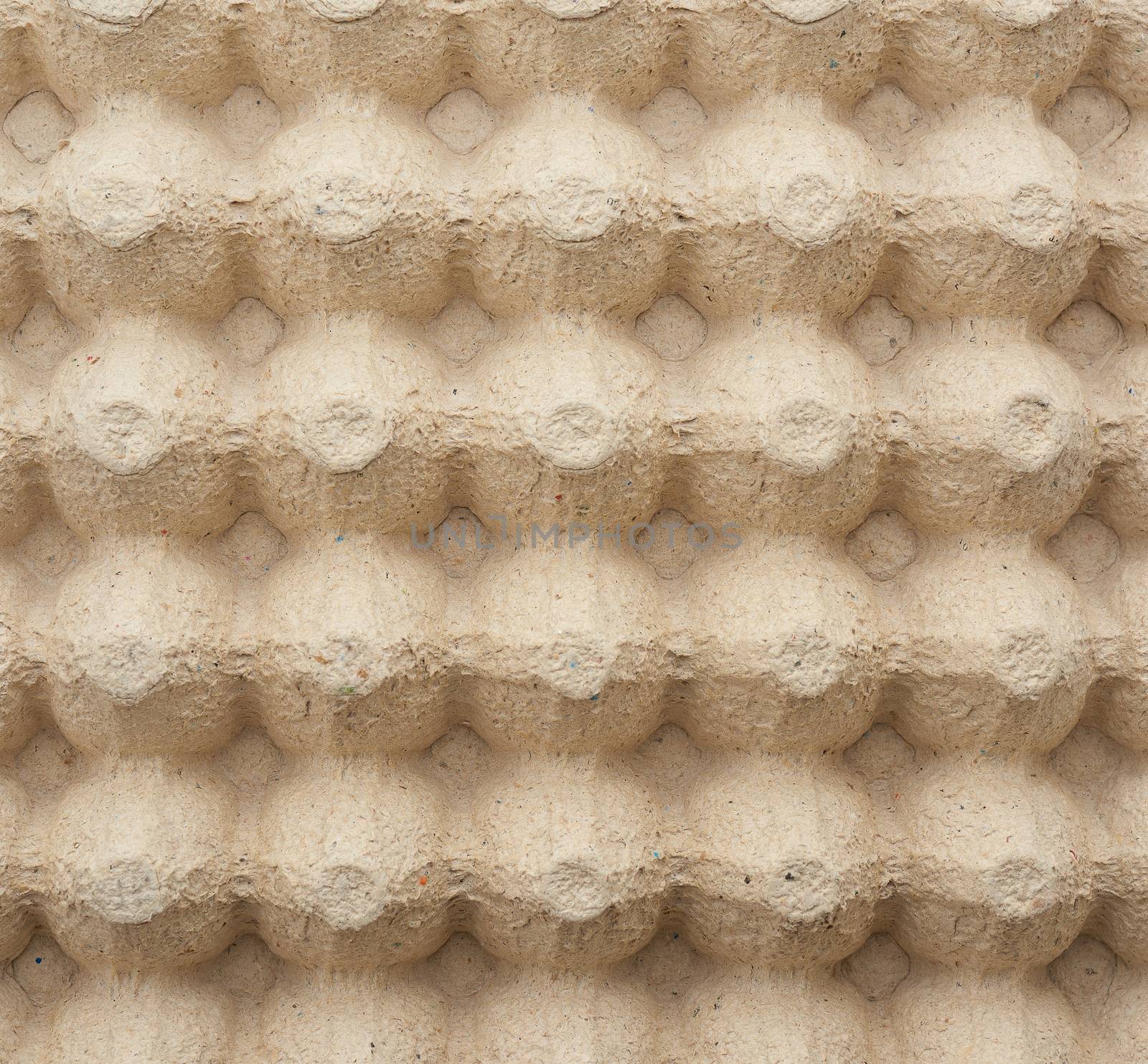 volumetric texture of a beige paper egg tray, full frame, close up
