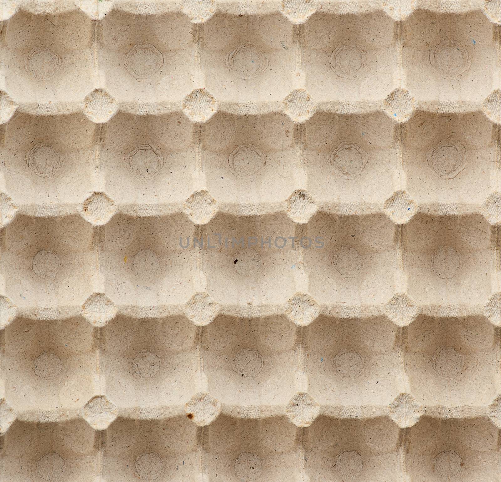 volumetric texture of a beige paper egg tray, full frame, close up