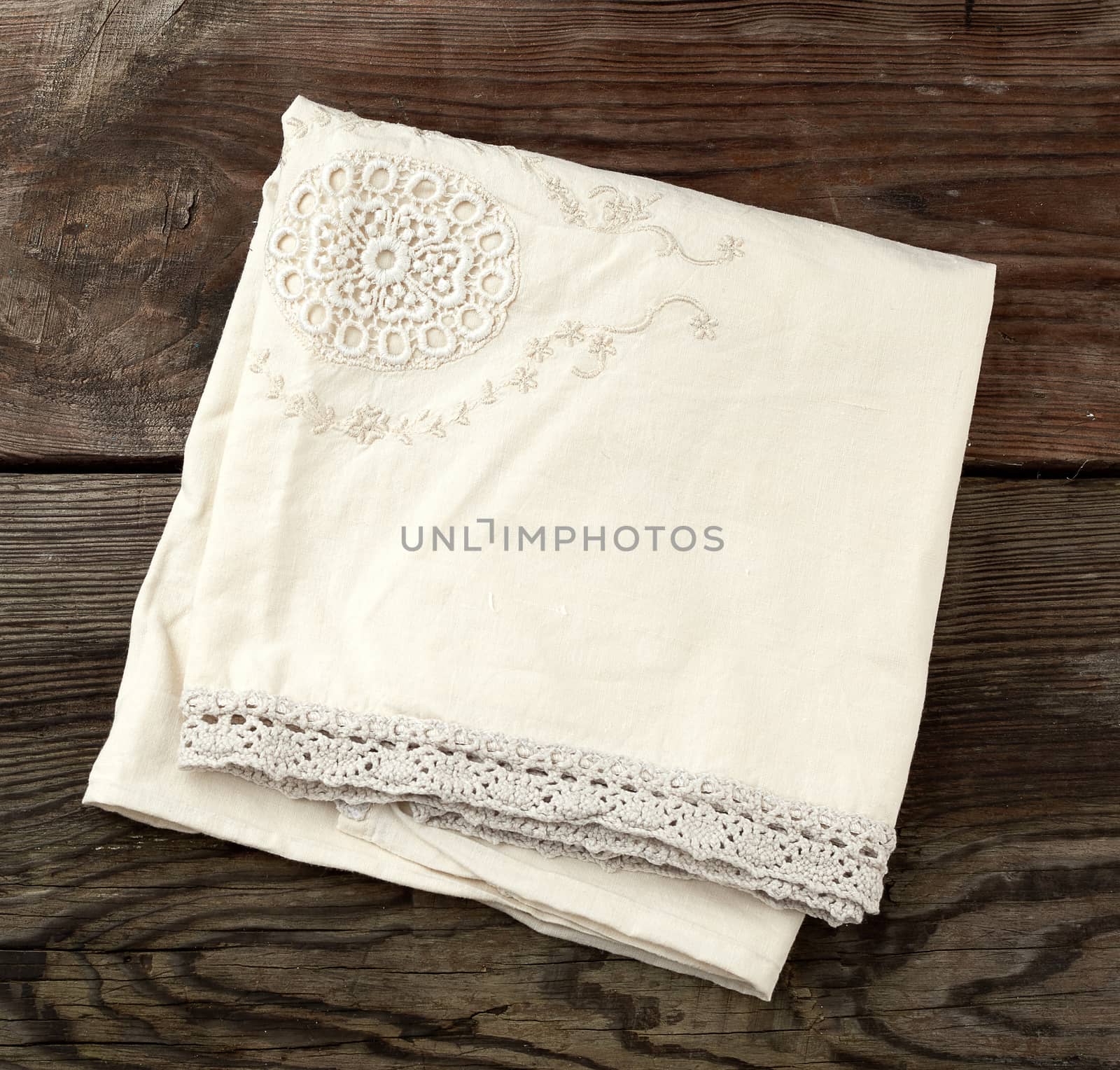 folded white napkin, kitchen wooden background in vintage style, copy space