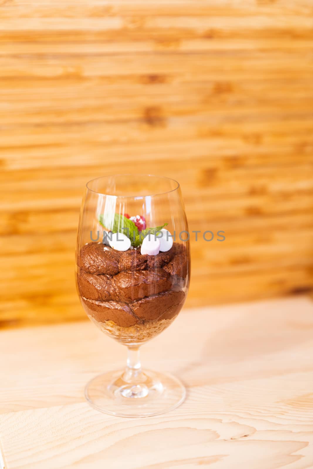 Glass filled with mousse chocolate and toppings