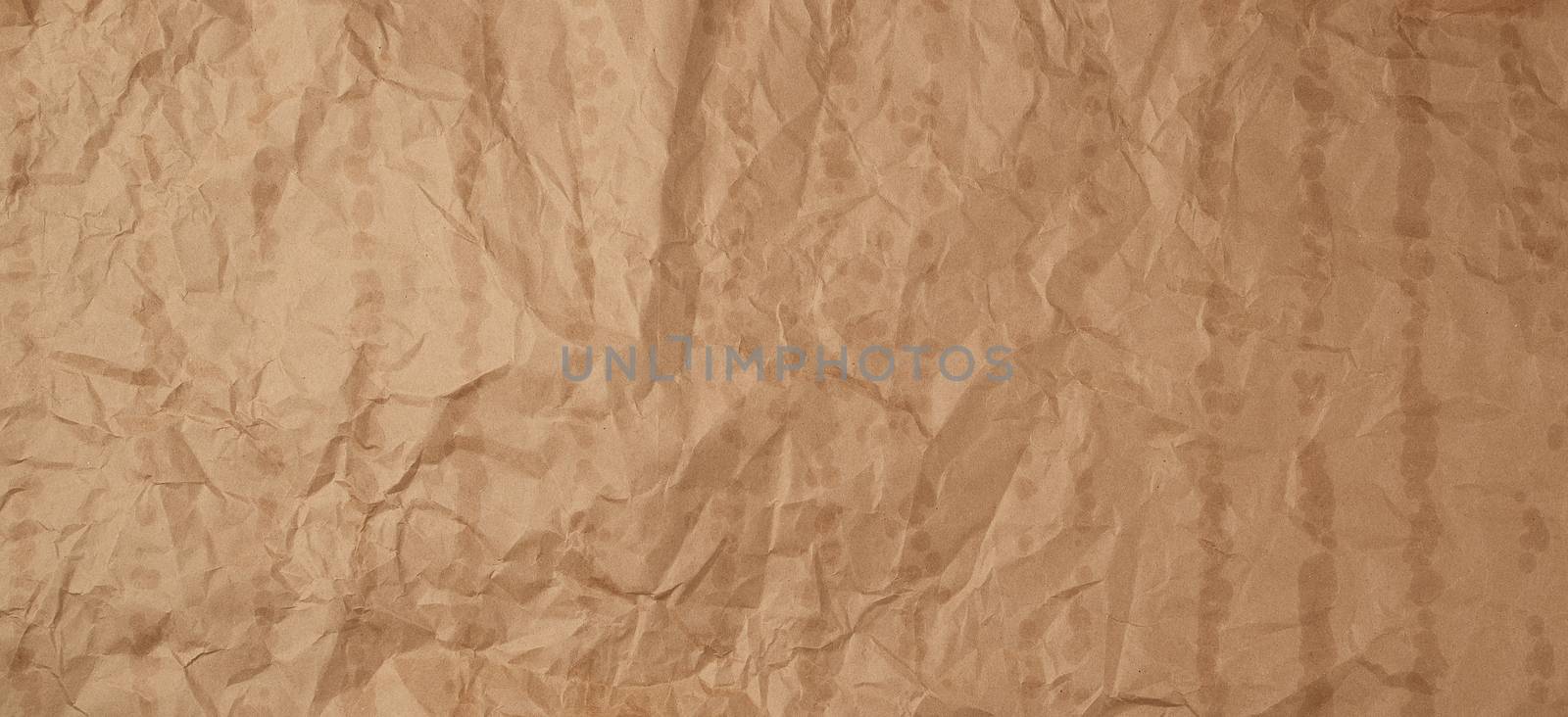 crumpled brown kraft paper texture with bold spots, full frame by ndanko