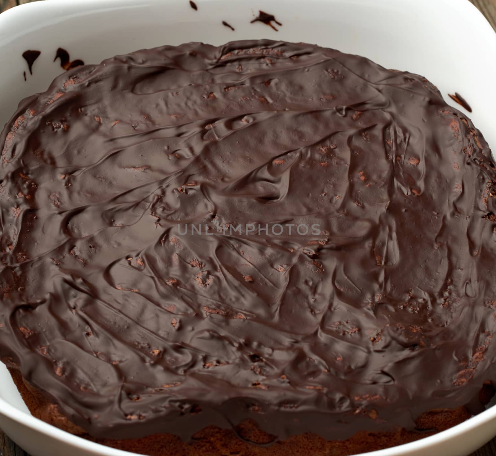 baked brownie chocolate cake in a white ceramic plate. Cooked homemade food. Chocolate pastry. Sweet meal, homemade dessert