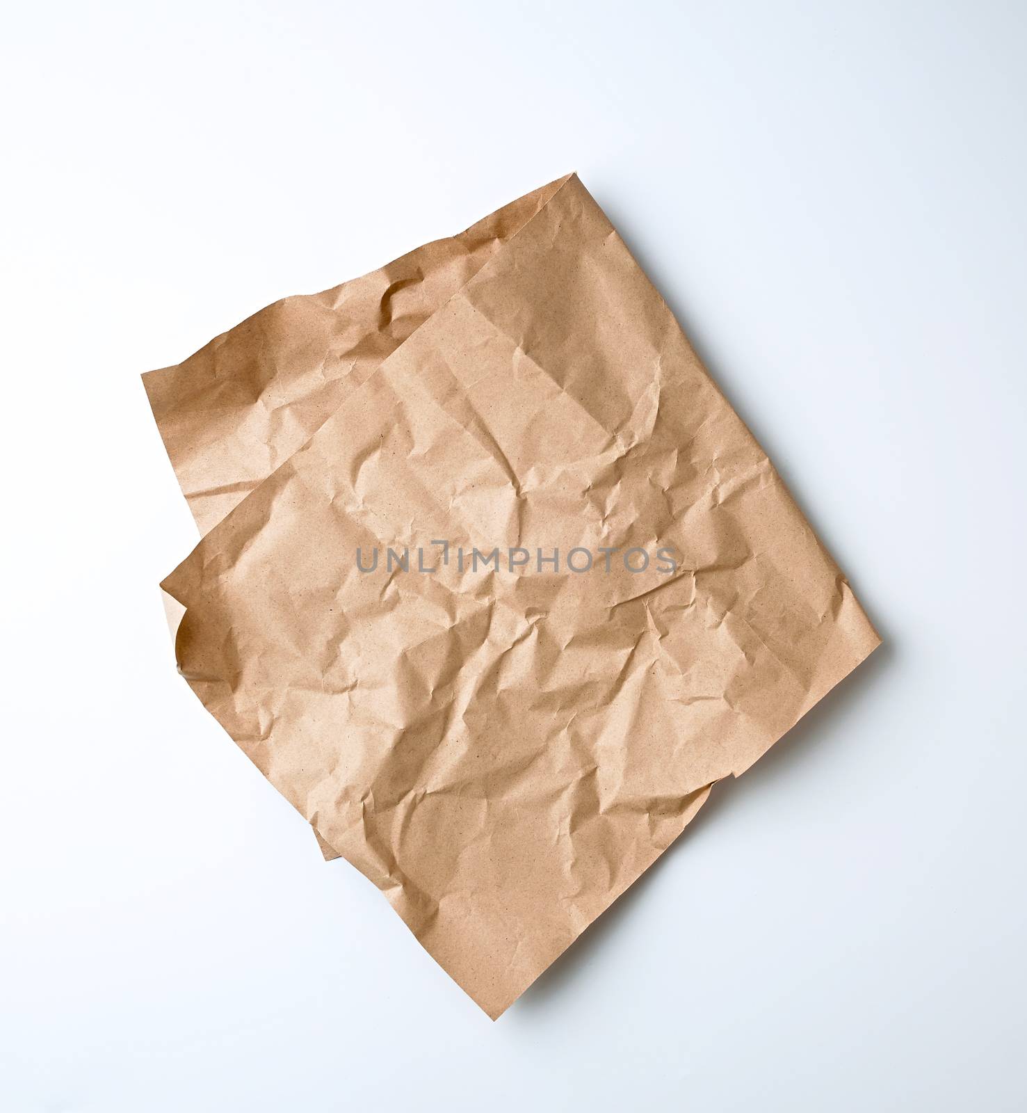 folded sheet of brown craft paper for packaging on a white background