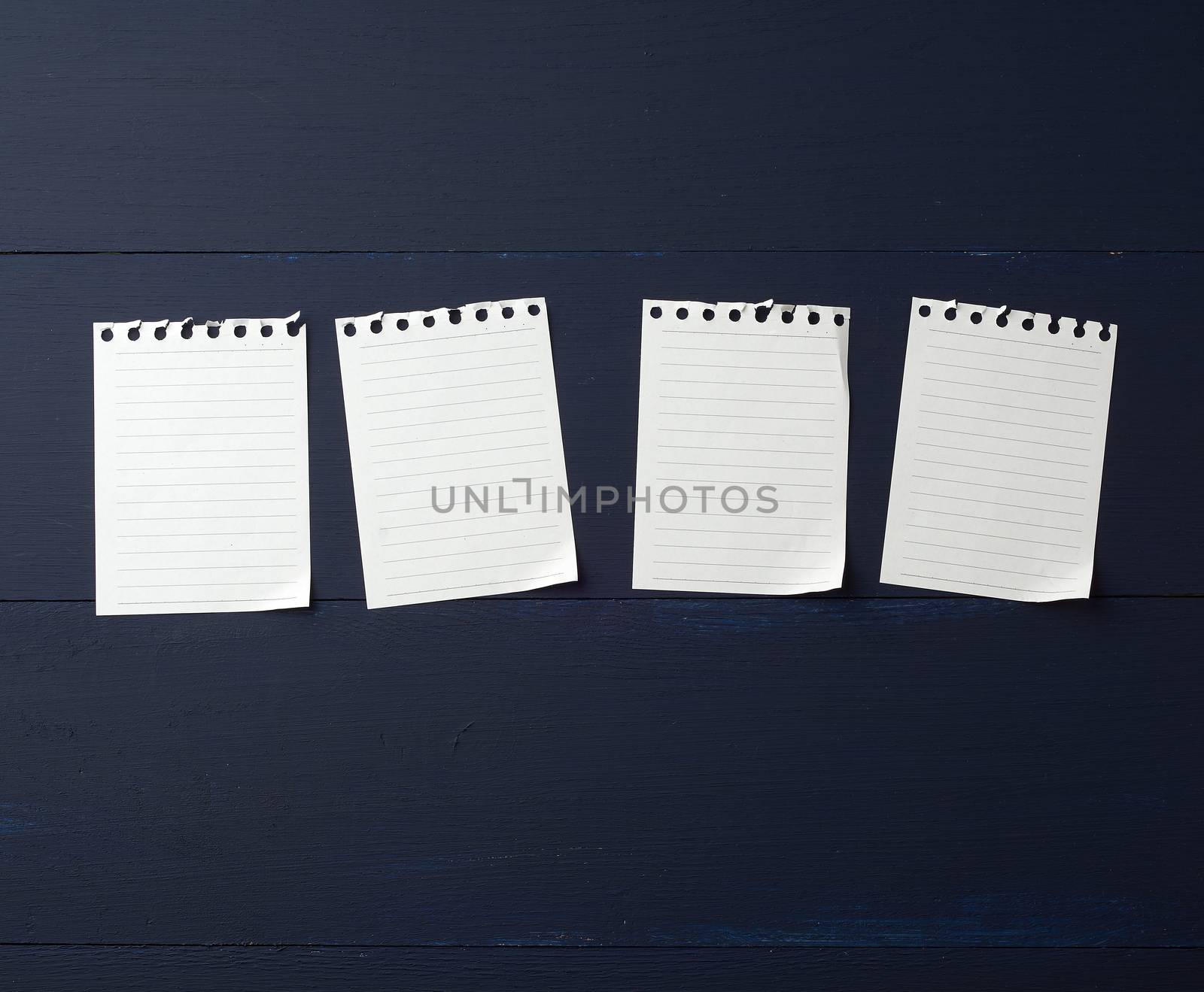 empty white small sheets of paper on a blue background. Mockup template. Business background.