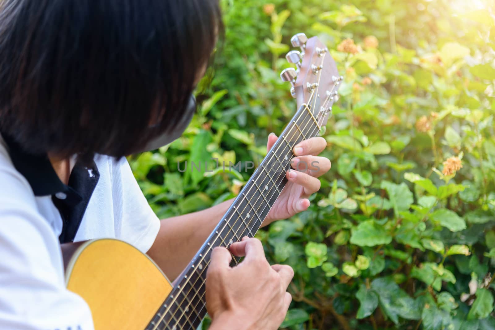 Guitarist playing the Harmonic tapping technic with acoustic guitar by rukawajung