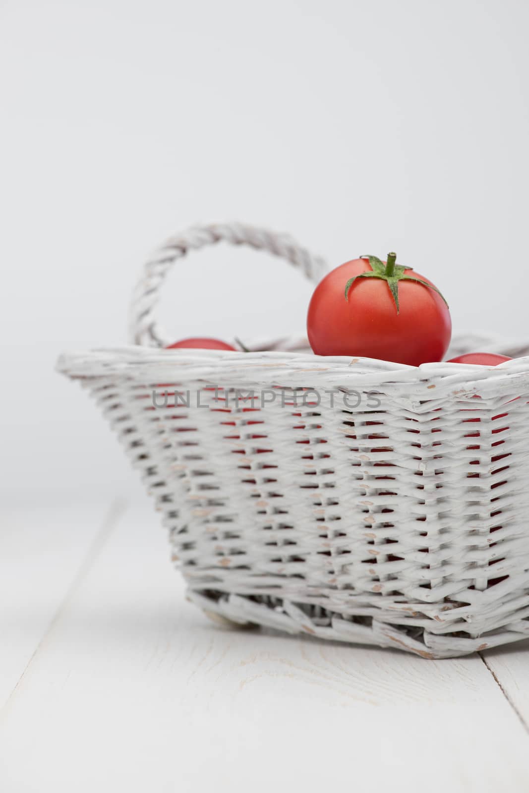 tomatoes in a white basket by A_Karim