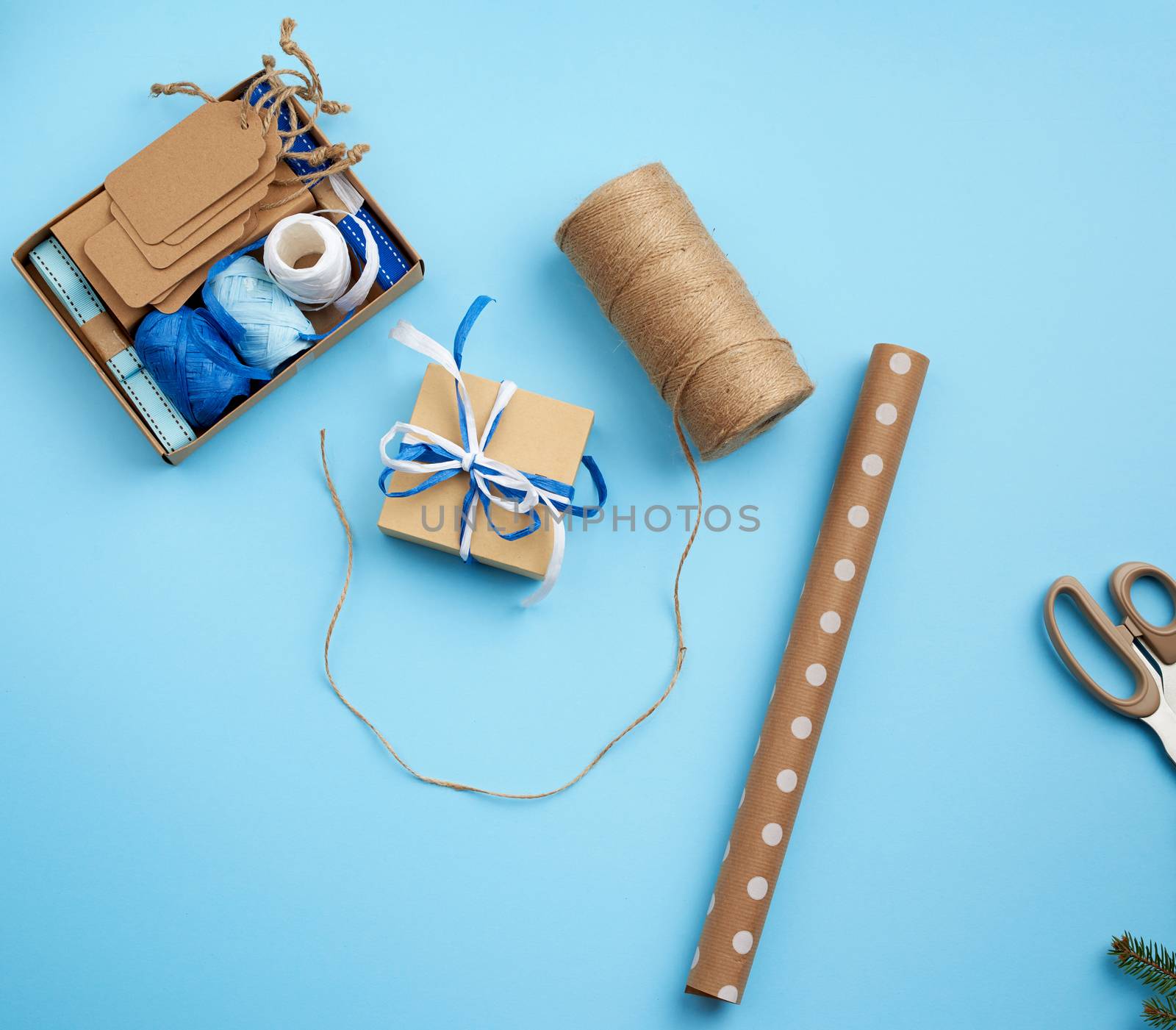 square gift box, rope and prize wrapping paper. Flat packaging. Festive christmas background.