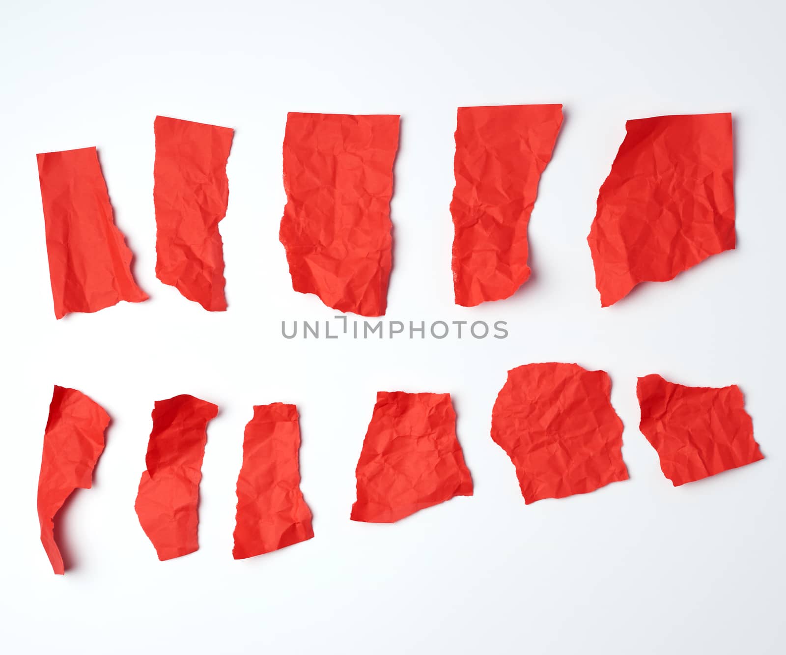 various crumpled blank pieces of red paper on white background, copy space
