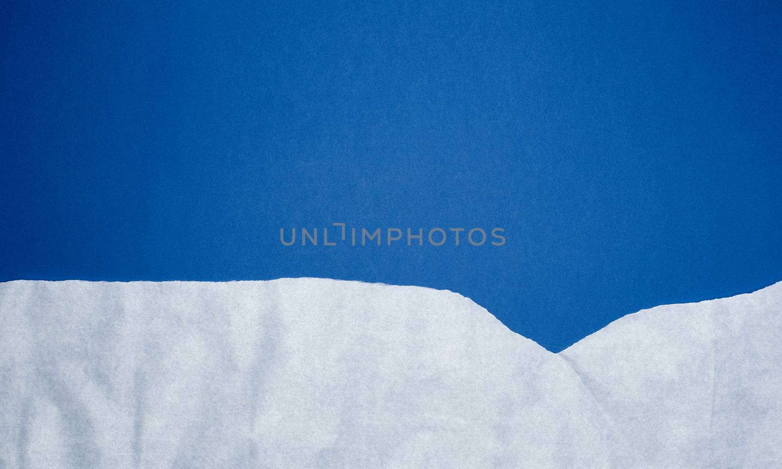 dark blue background with white crumpled torn paper elements, place for writing op in the middle, template