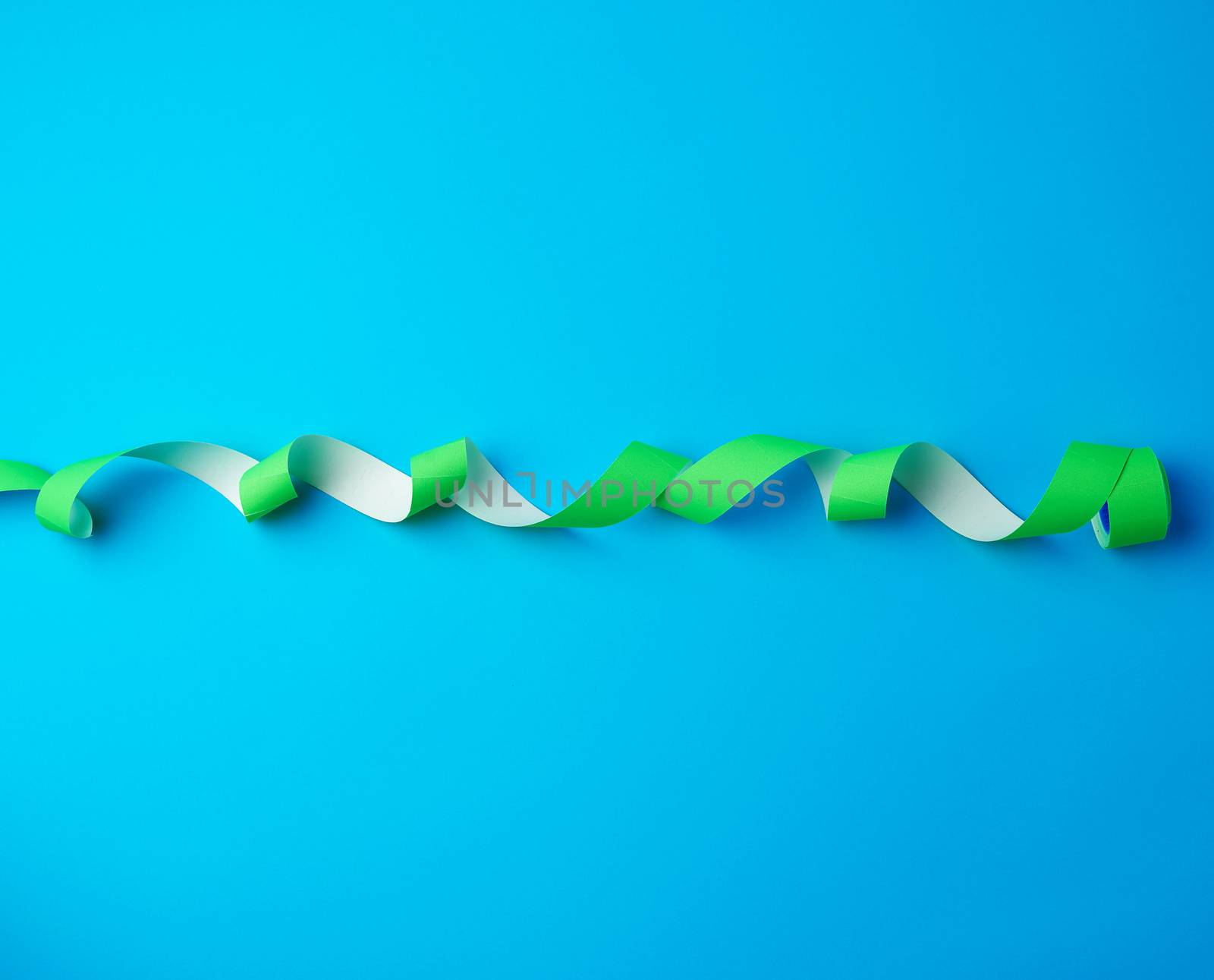 untwisted reel with green sticky stickers on a blue background, top view