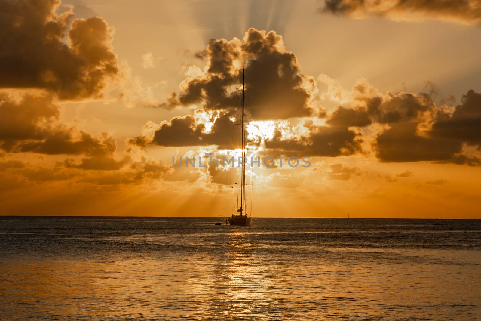 Sunset view of yacht anchored in the lagoon, Britannia bay, Mustique island, Saint Vincent and the Grenadines, Caribbean sea