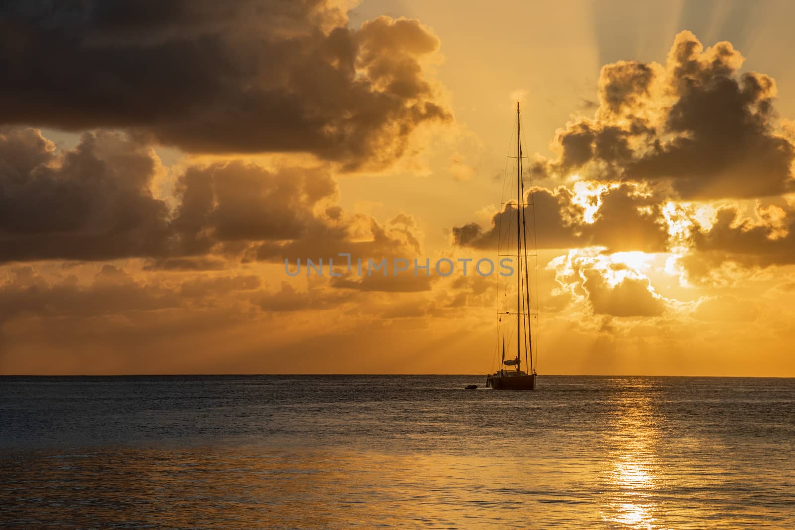 Sunset view of yacht anchored in the lagoon, Britannia bay, Mustique island, Saint Vincent and the Grenadines, Caribbean sea