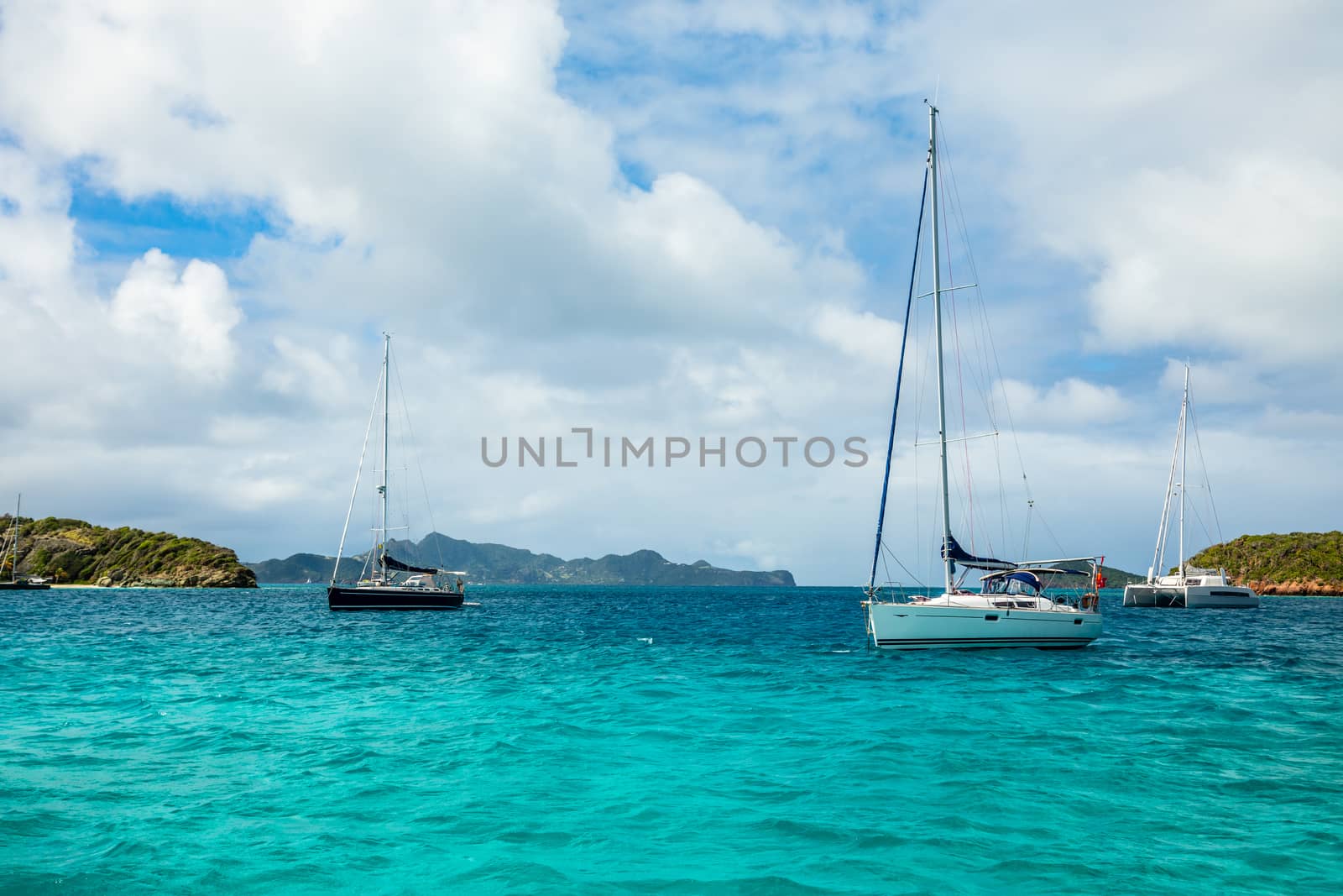 Turquoise sea and anchored yachts and catamarans, Tobago Cays, Saint Vincent and the Grenadines, Caribbean sea