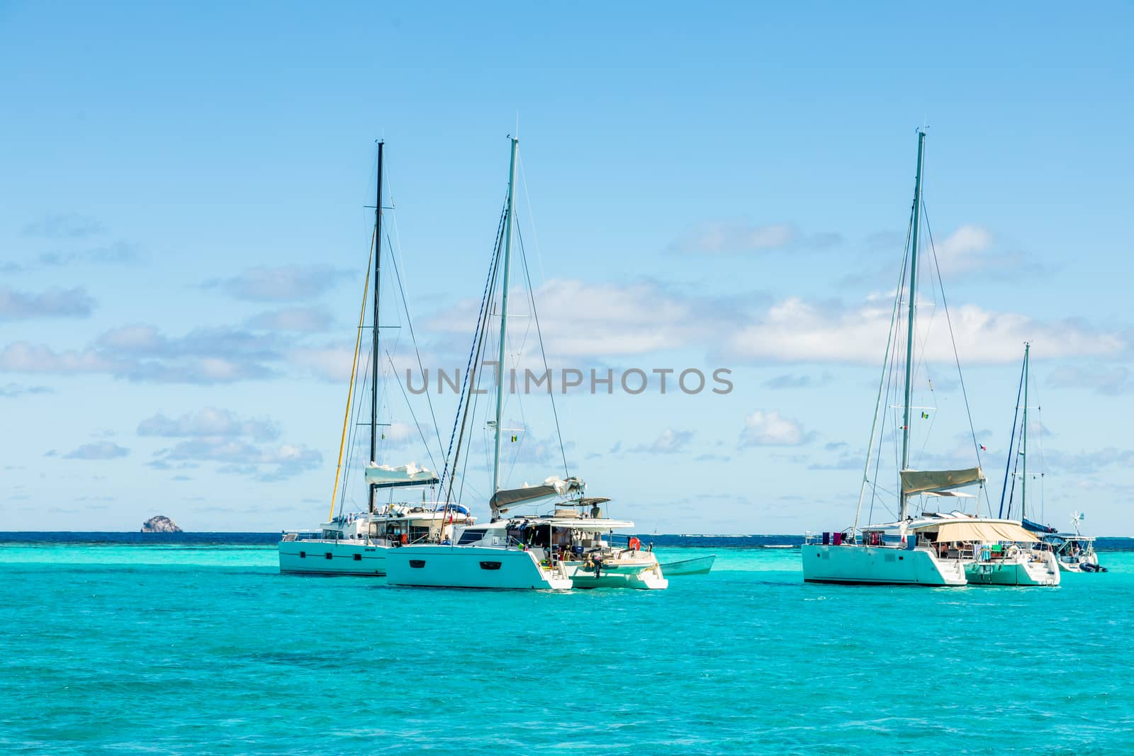 Turquoise colored sea with ancored catamarans, Tobago Cays, Saint Vincent and the Grenadines, Caribbean sea