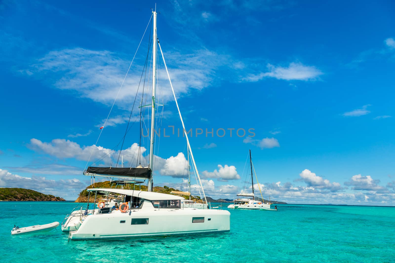 Turquoise colored sea with ancored catamarans, Tobago Cays, Sain by ambeon