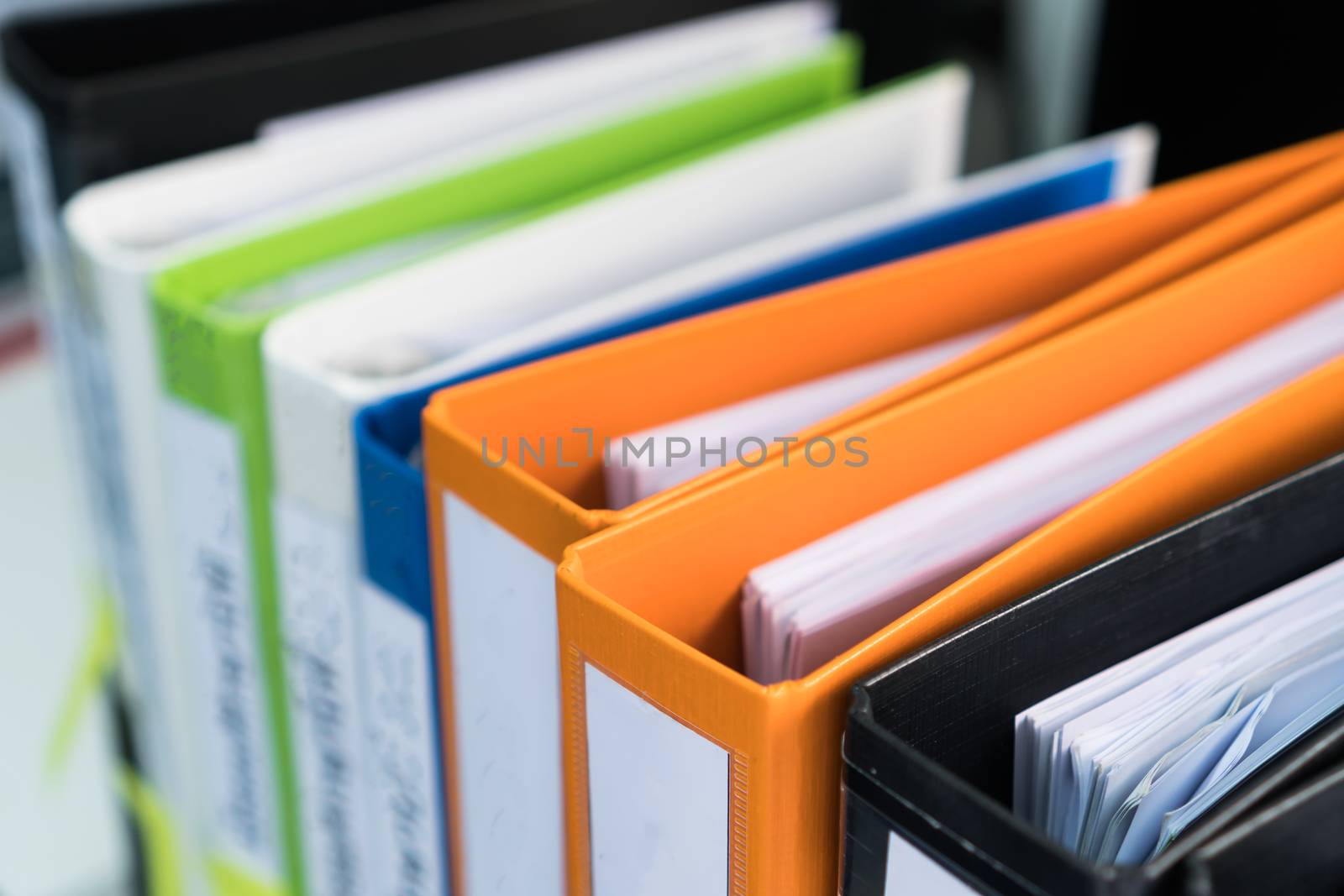 Document binder file folders stack on office desk in organizatio by smolaw11