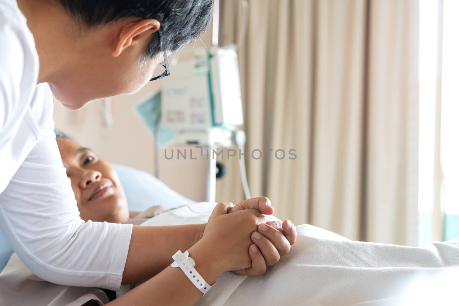 Love hope concept: Happy Daughter Visits mother holding hand for recovering that sick lying on bed in Hospital, looking with hopeful emotional, Patient smiling with happy when get support from family