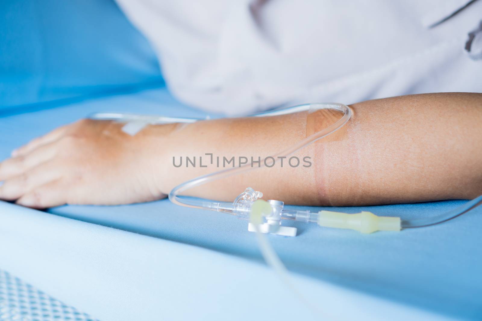 Patients saline, Iv drip, young woman hand with medical drip int by smolaw11