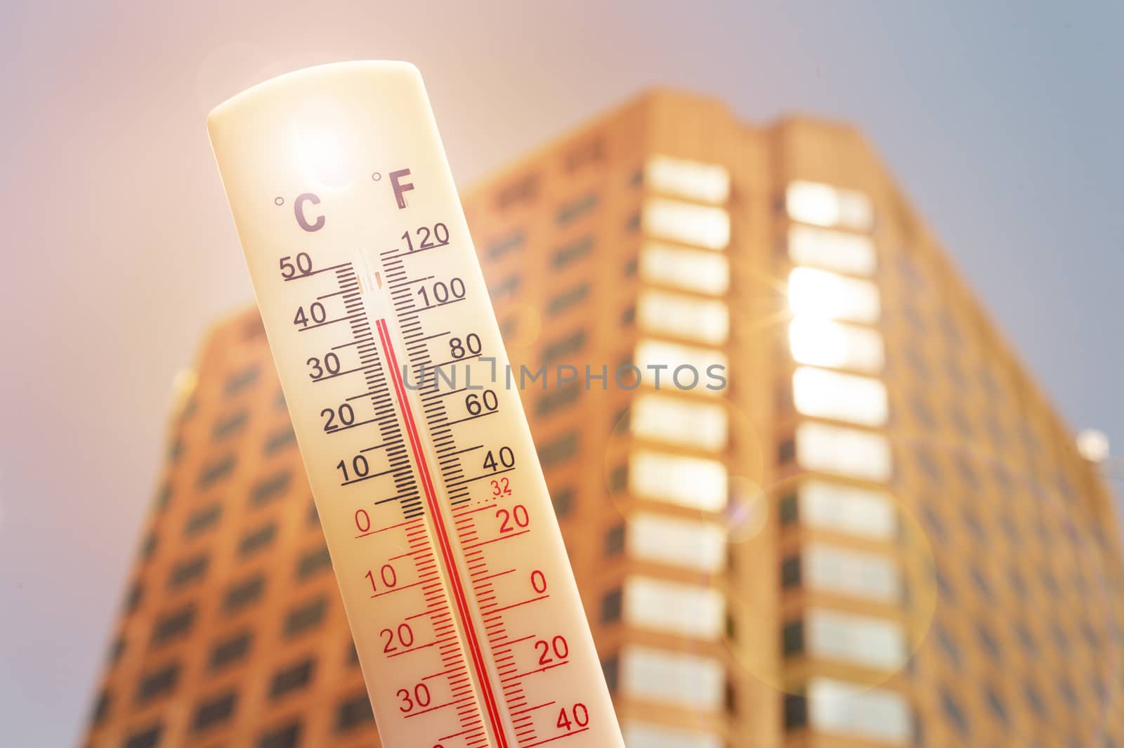 Thermometer in front of an urban scene during heatwave in Montreal