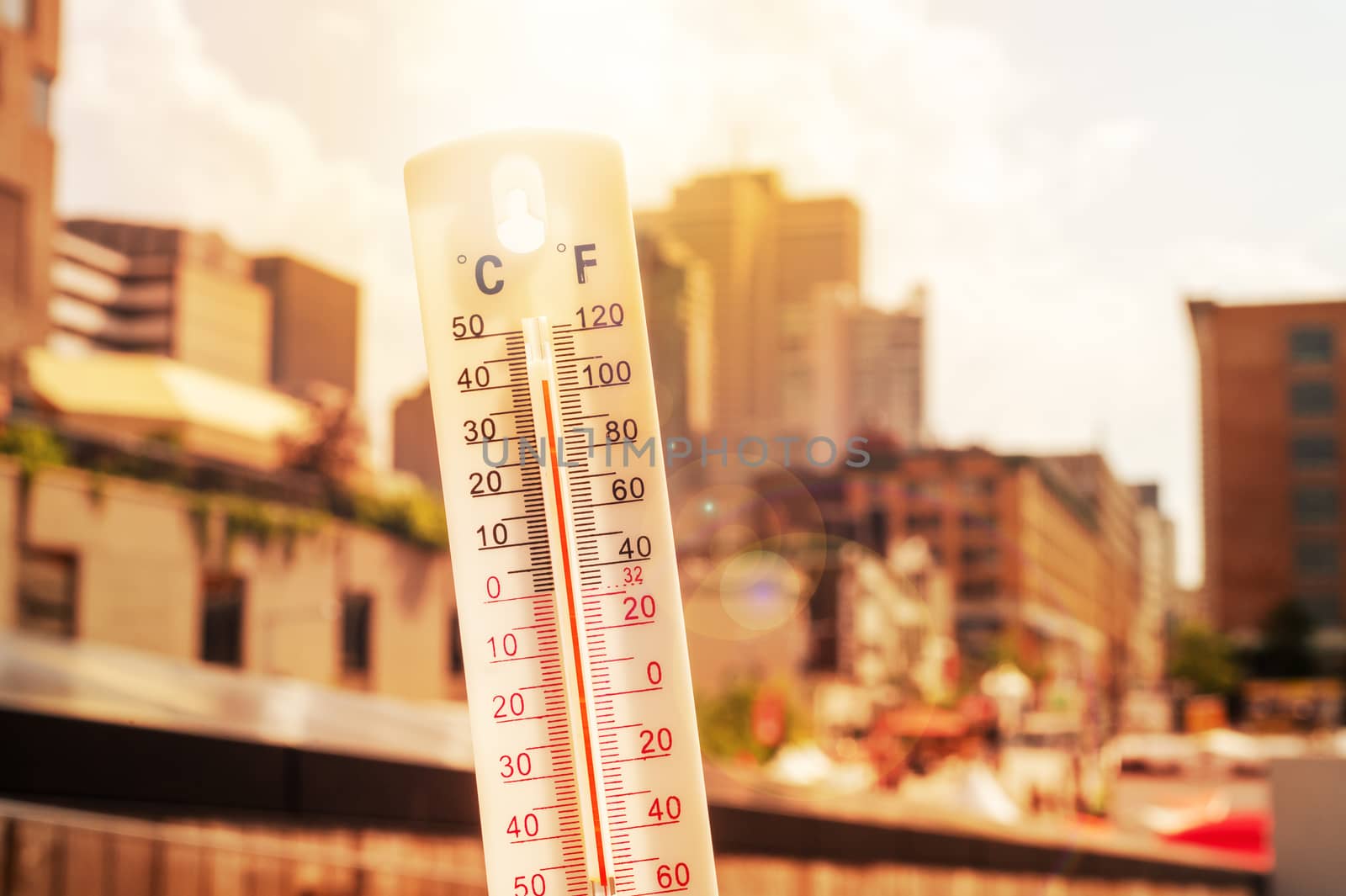Thermometer in front of an urban scene during heatwave by mbruxelle