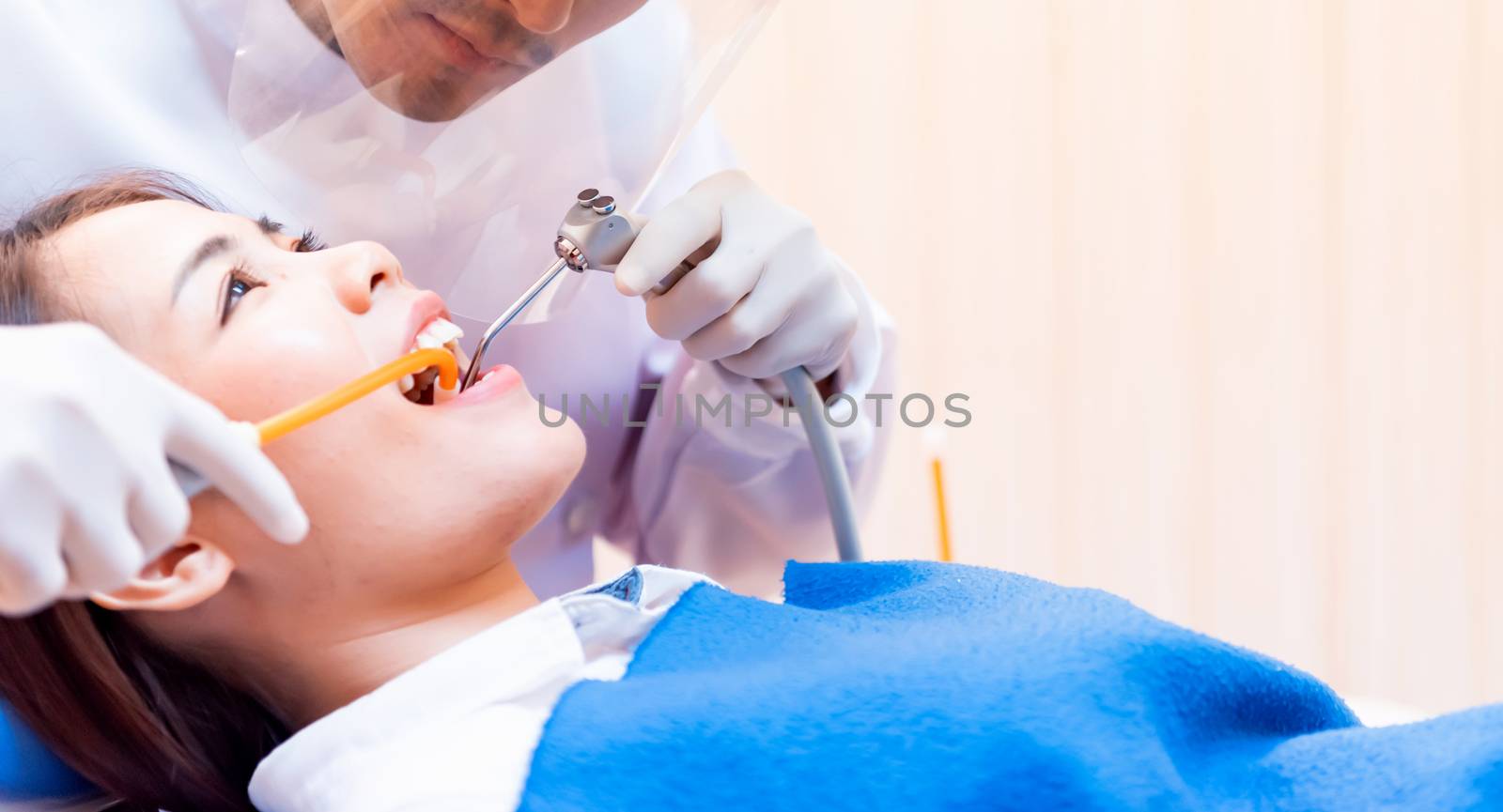 Dentistry and teeth healthcare concept at dental clinic. Dentist check-up teeth for young asian patient.