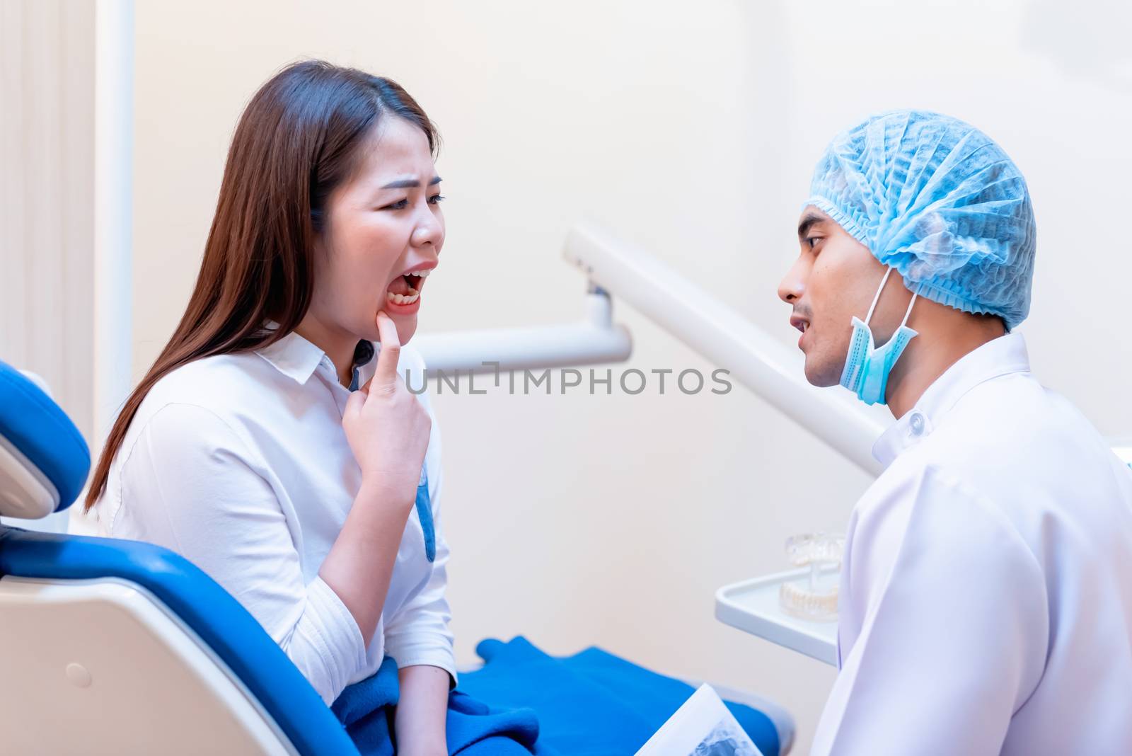 Dentistry and teeth healthcare concept at dental clinic. Dentist check-up teeth for young asian patient.