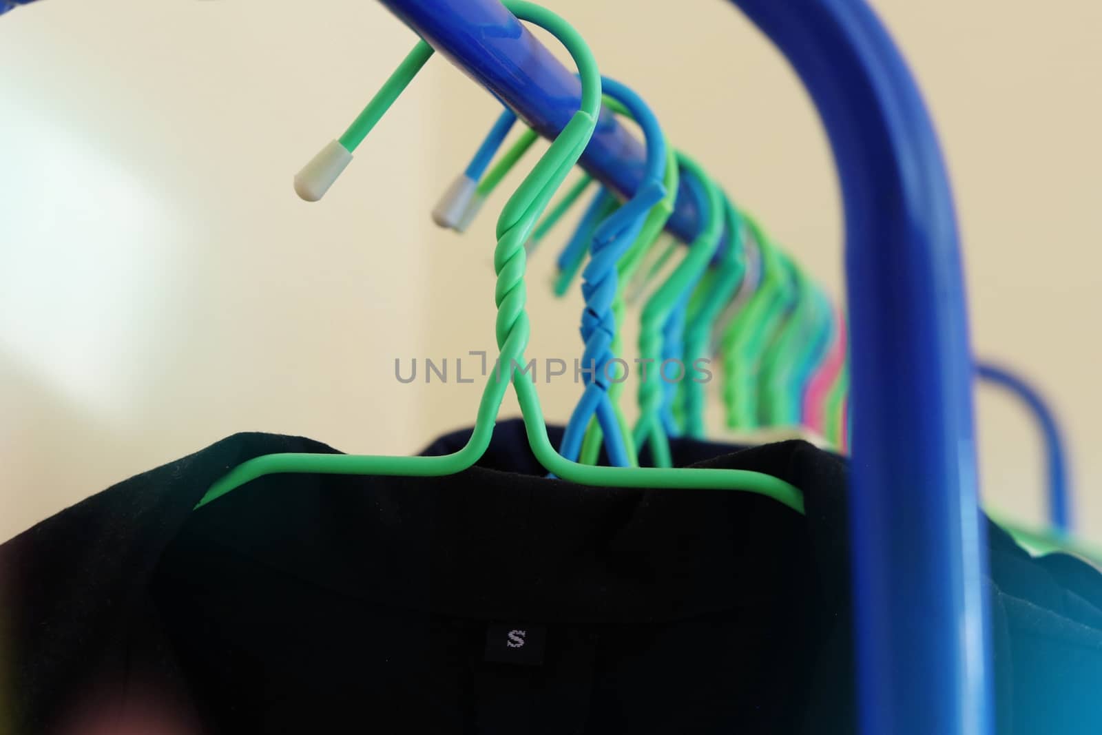 Selective focus of clothes hanging on rack with light effect