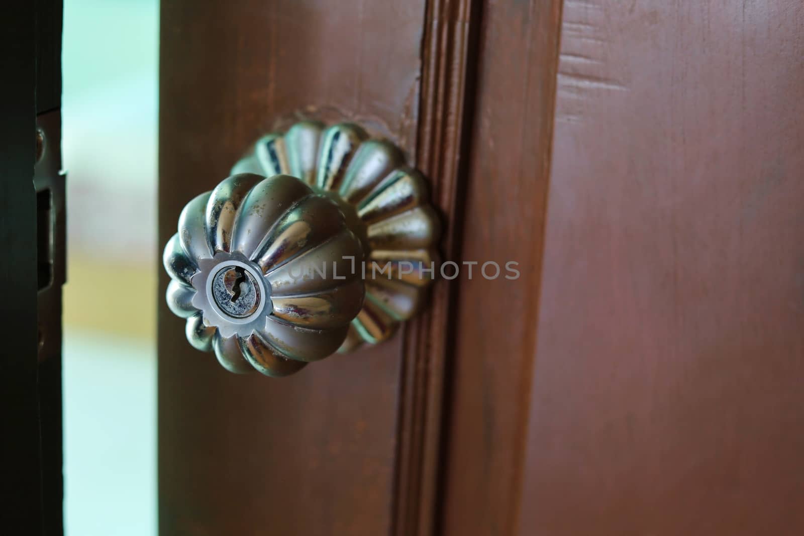 Slightly opened wooden door to the room.