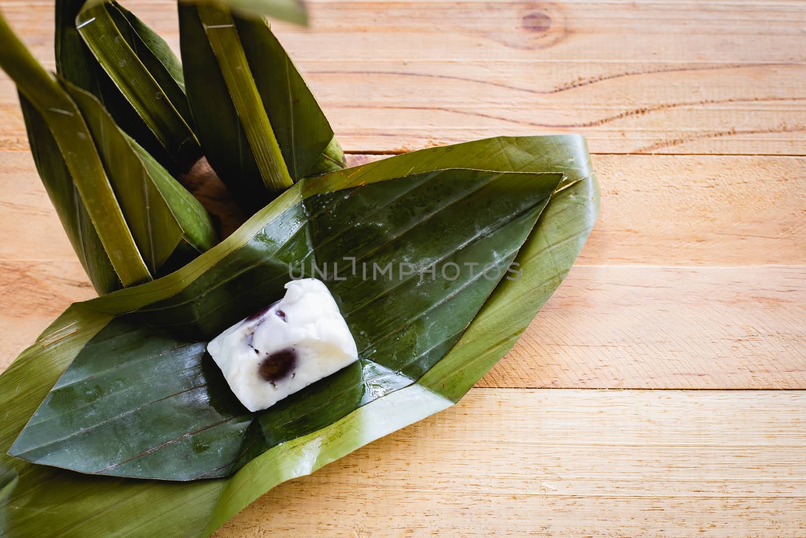Steamed flour custard with sweet coconut filling on wooden background for Thai dessert concept