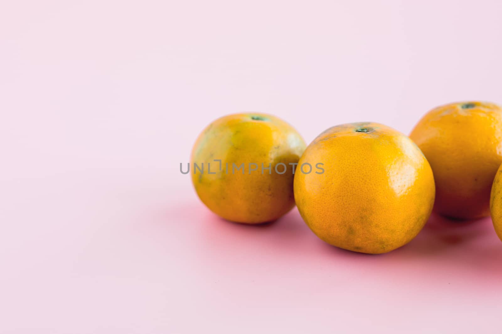 Orange on pink background for fruit and eating concept