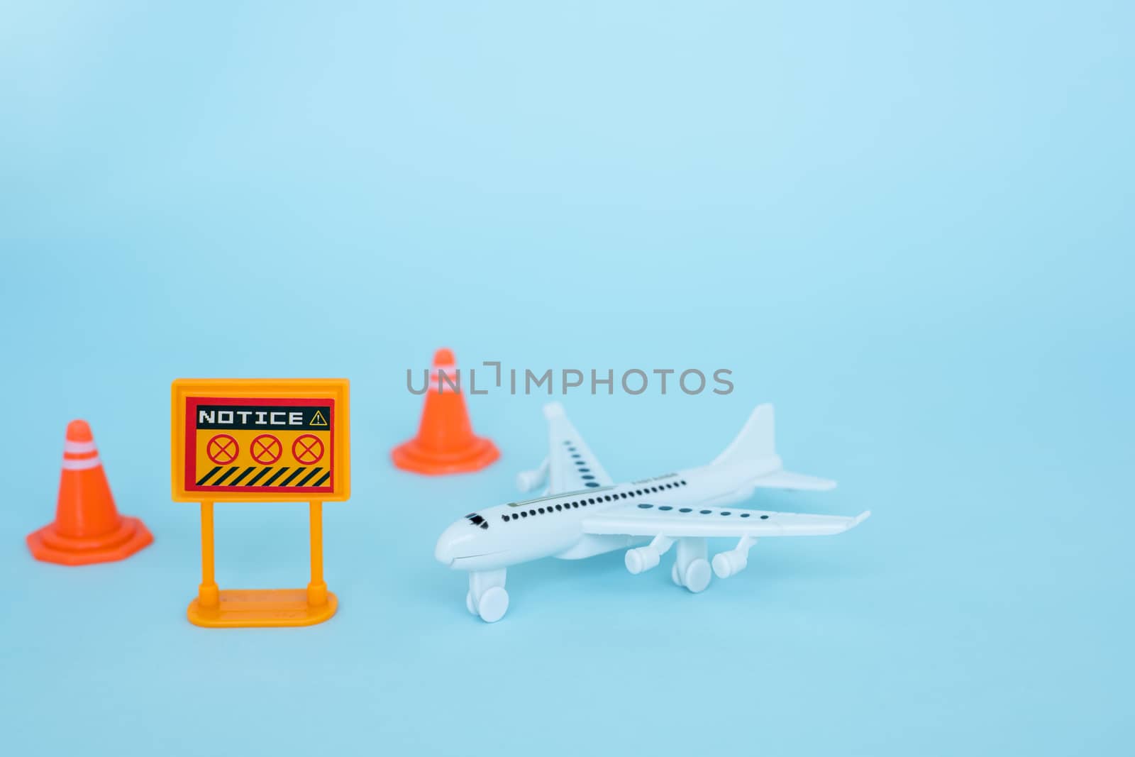 White airplane model with prohibition sign on blue background for vehicle and transportation in coronavirus or Covid-2019 situation concept