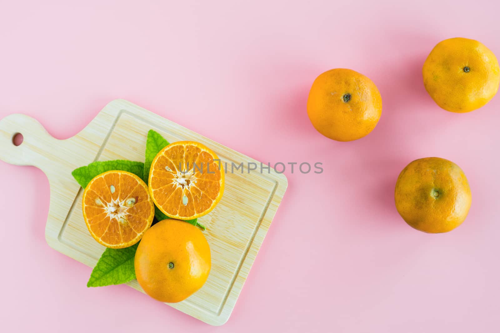 Orange on pink background for fruit and eating concept