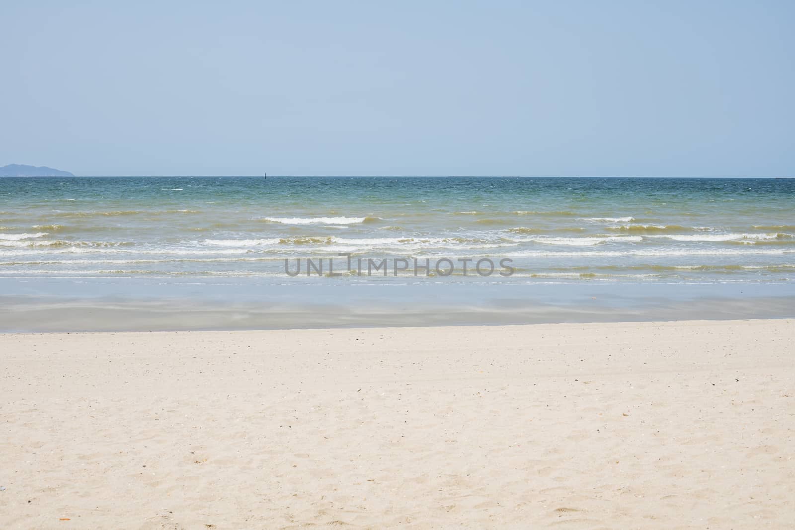 Beautiful beach with white sand and blue and clear sky background for travel and nature concept