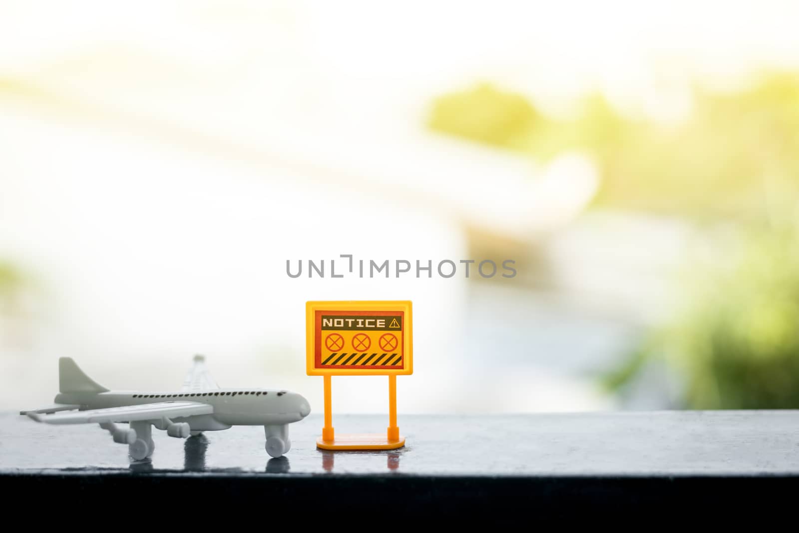 White airplane model with prohibition sign on blurred outdoor background for vehicle and transportation in coronavirus or Covid-2019 situation concept