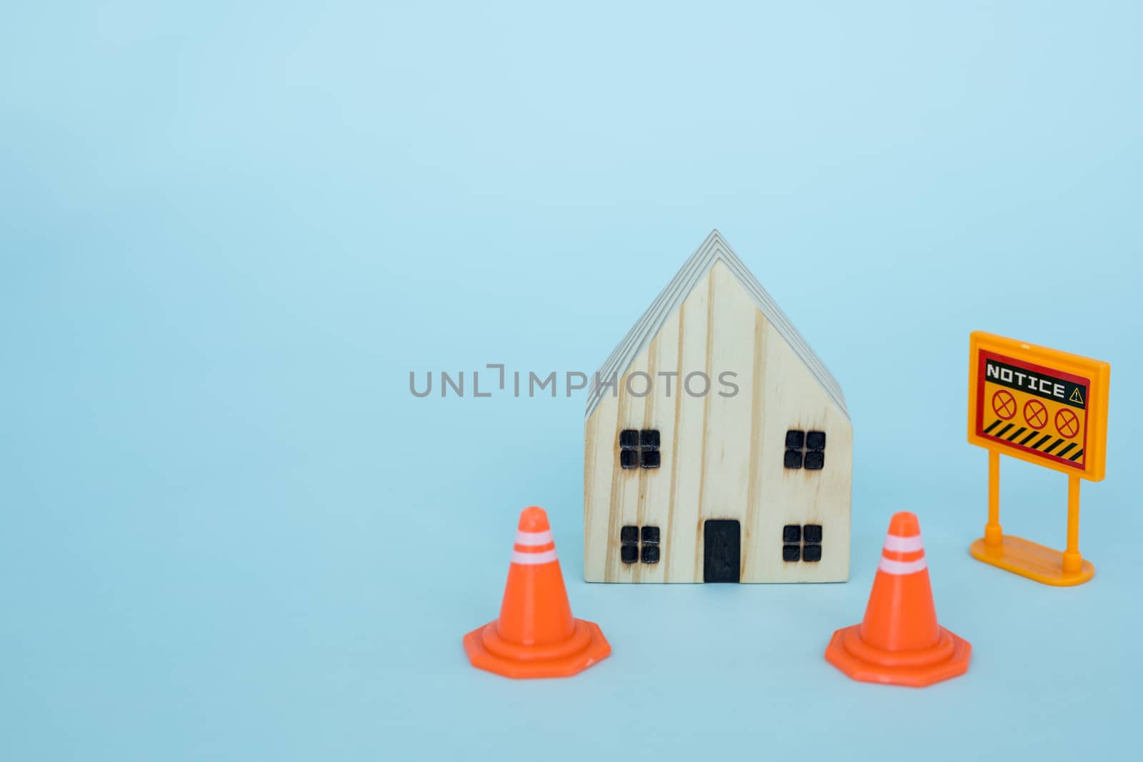Prohibition sign with wooden house model on blue background for self-quarantine and staying home in coronavirus or Covid-2019 situation concept