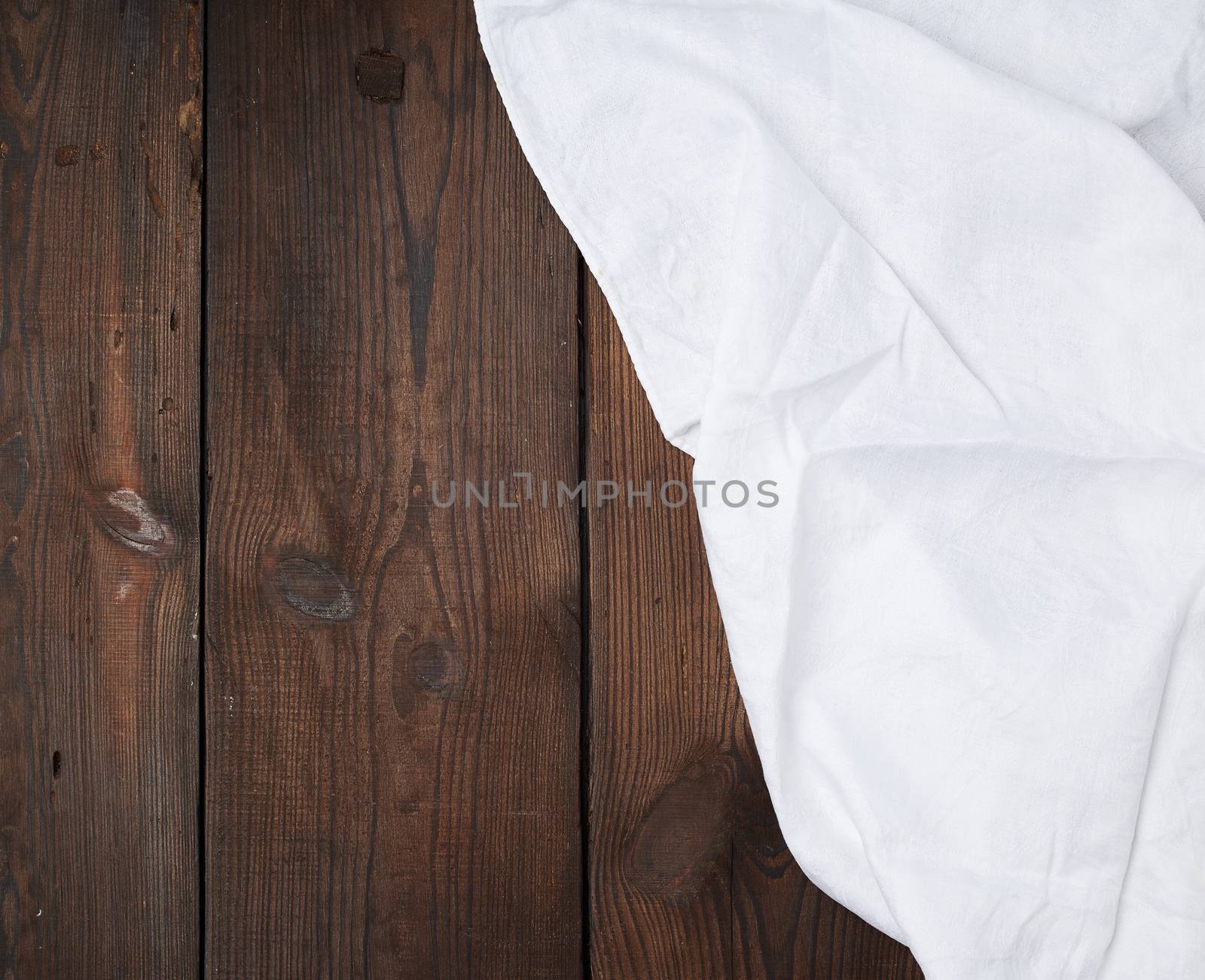 white linen towel on wooden background, top view, copy space