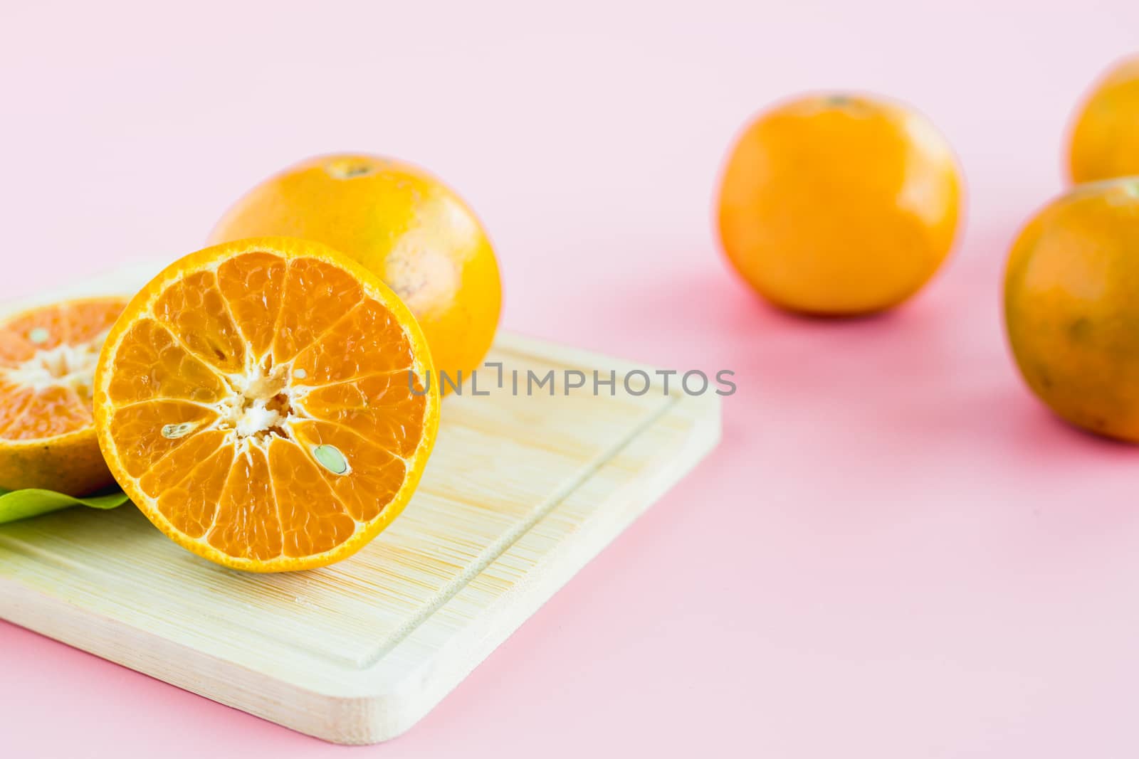 Orange on pink background for fruit and eating concept