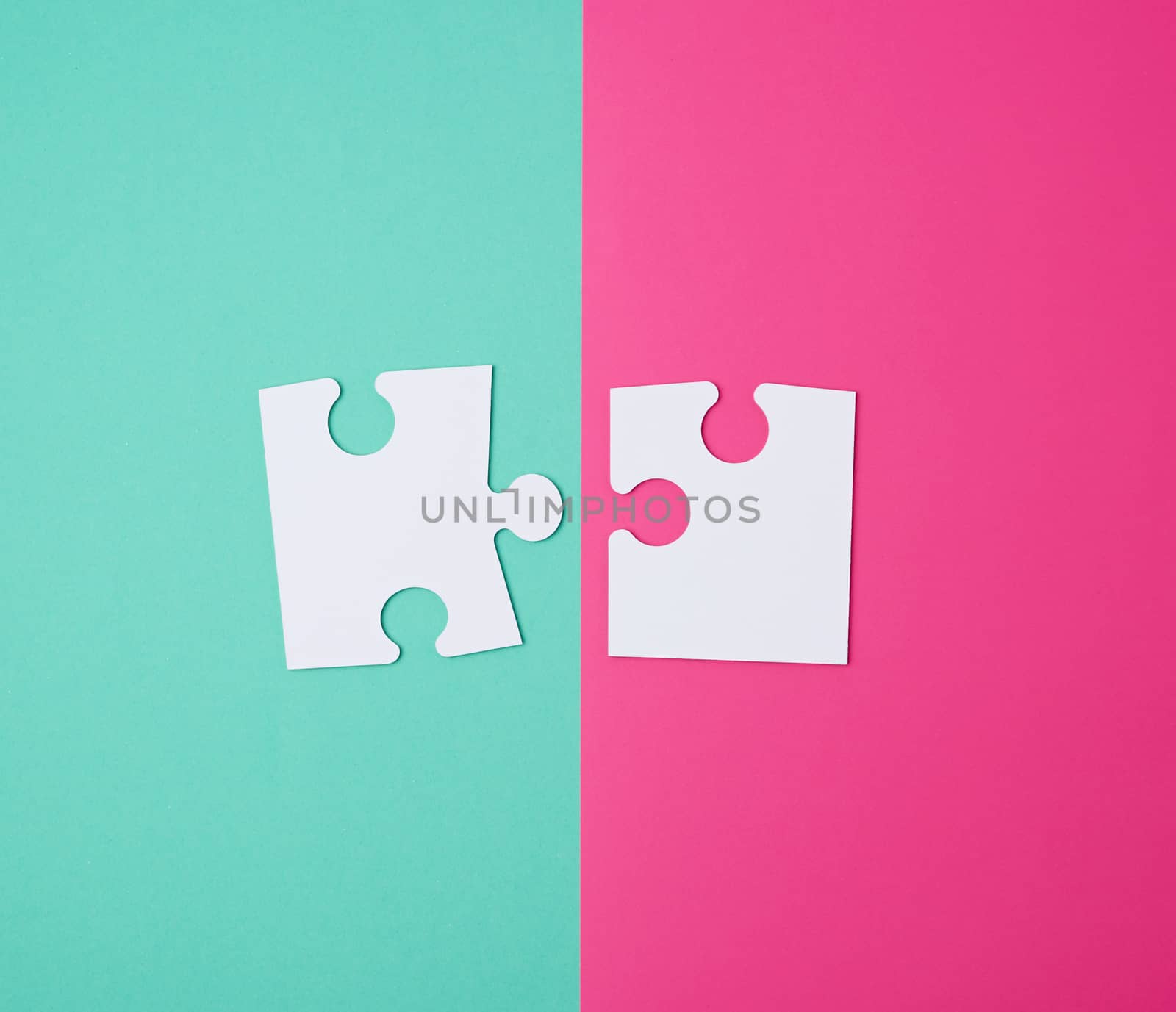 white large blank puzzles on a pink green background, top view, copy space