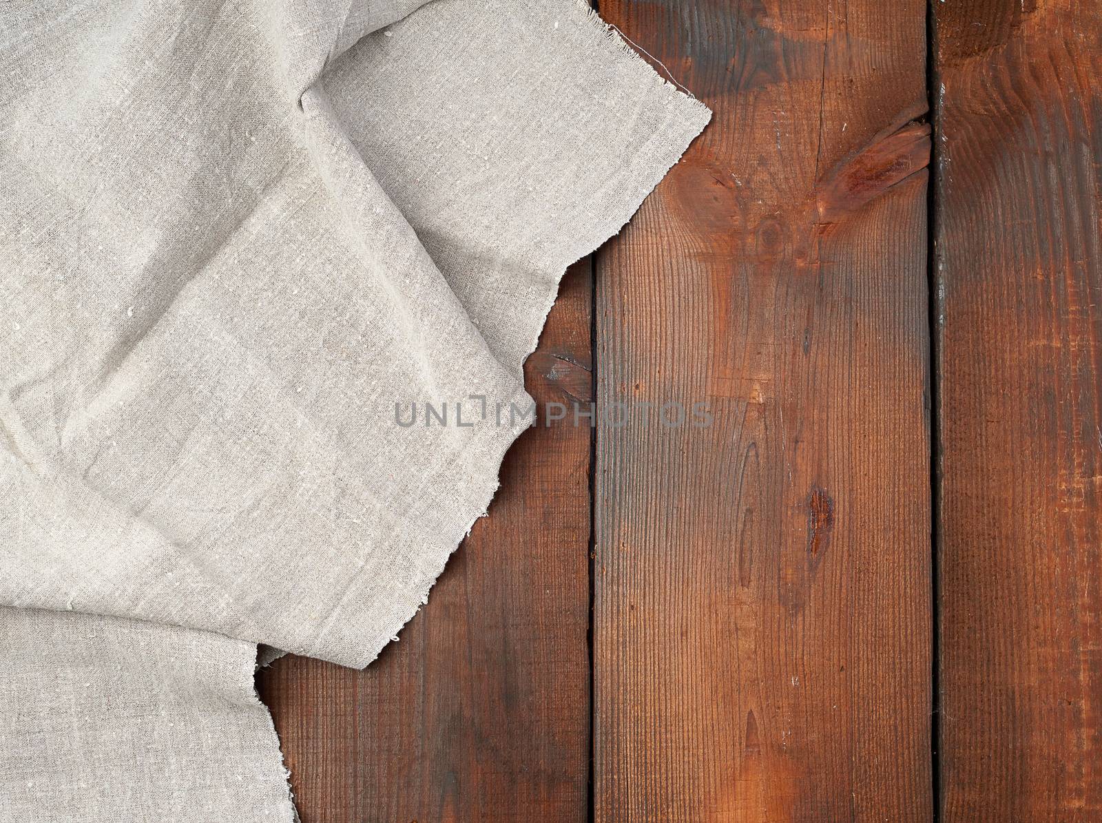 gray linen towel on wooden background, top view, copy space
