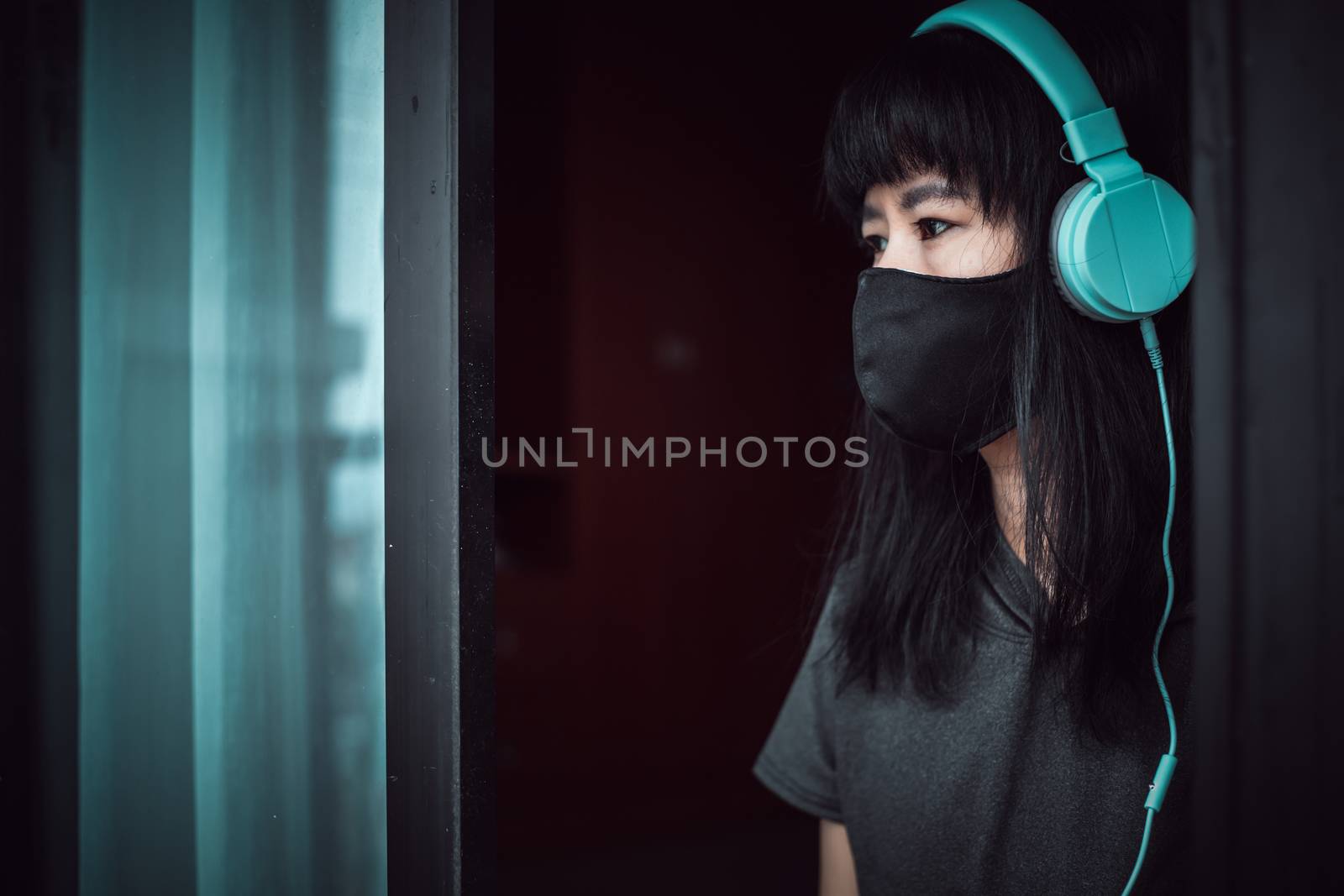 Asian woman staying home for self-quarantine and social distancing by iamnoonmai