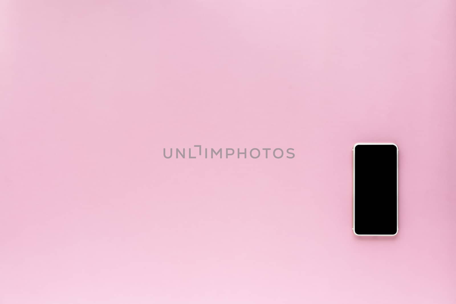 Smartphone on pink background with copy space for communication and media technology concept