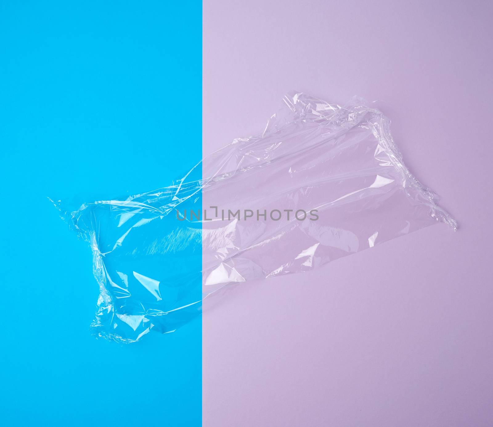 transparent white polyethylene for wrapping products and packaging goods on a colored background, top view