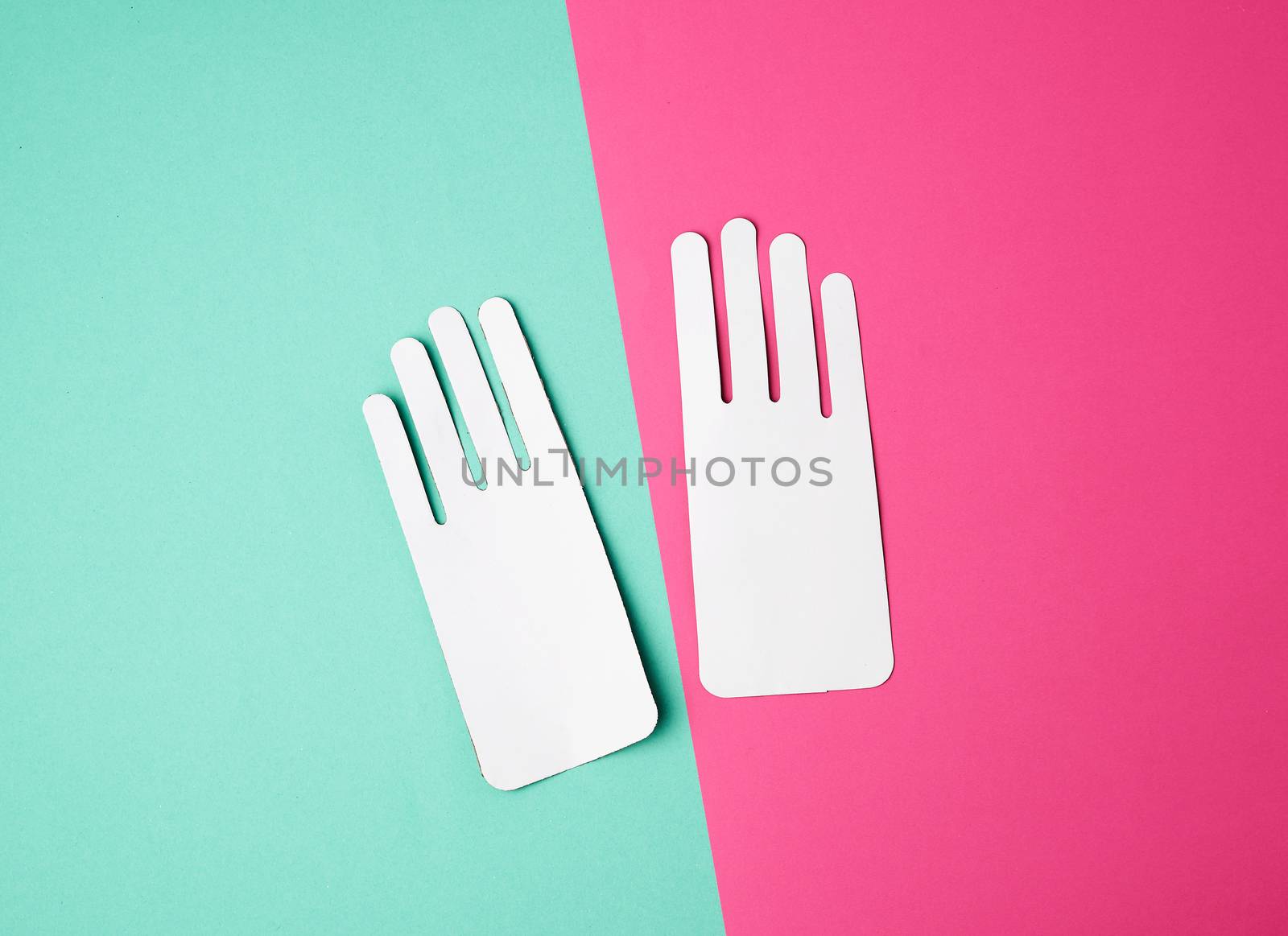 two empty paper white patterns for gloves on a colored background