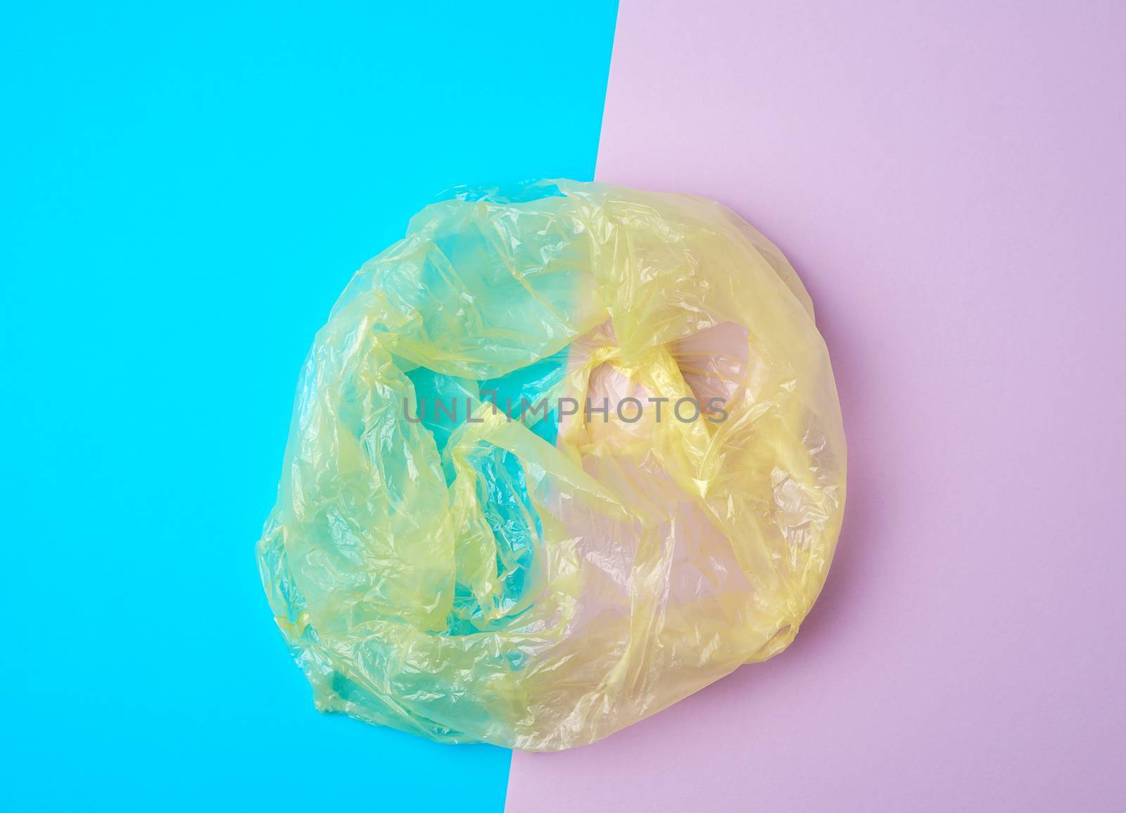 open empty plastic bag for products on a colored background, concept of rejection of plastic bags to save the environment
