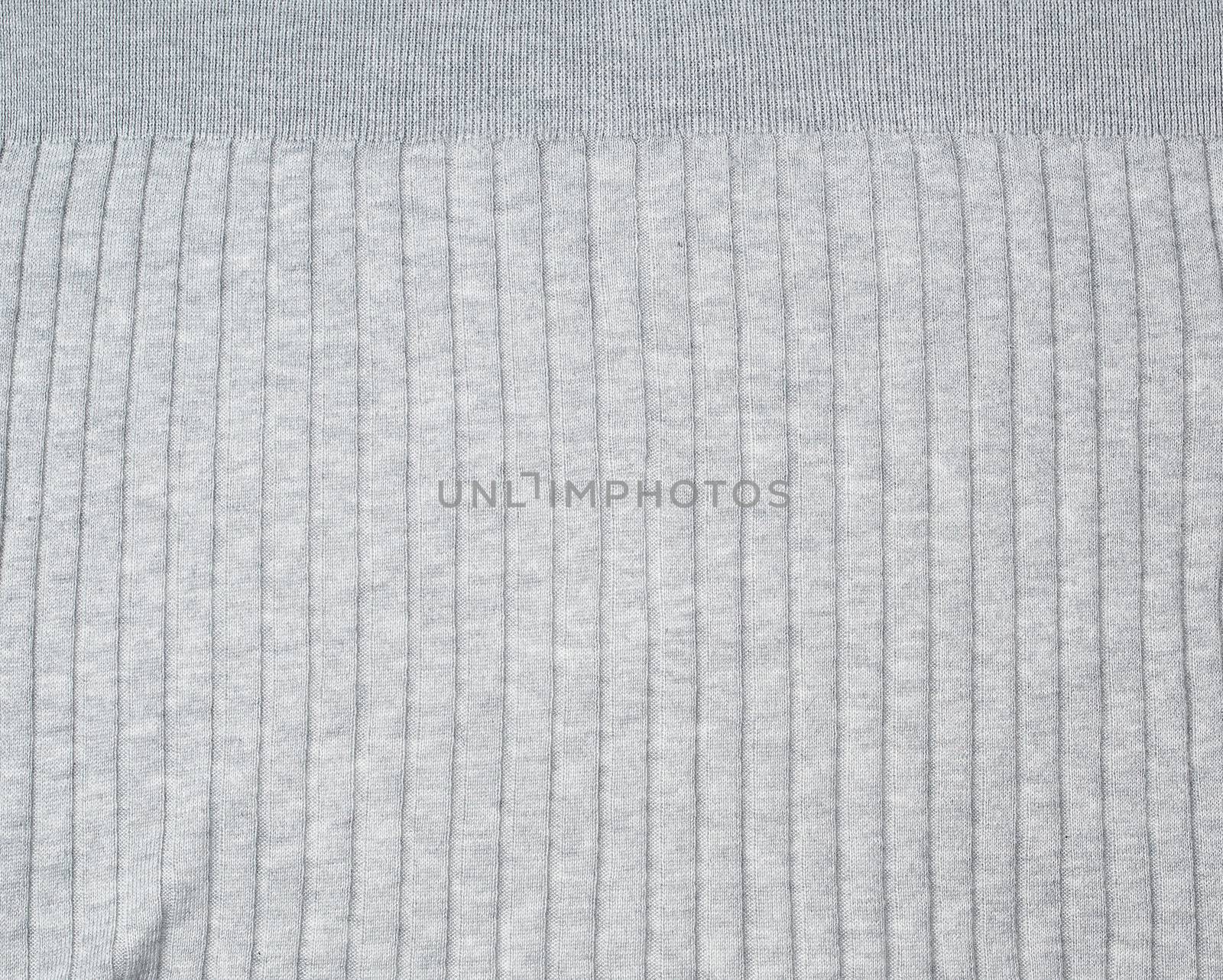 fragment of gray knitted fabric, full frame, fabric for sweaters, close up