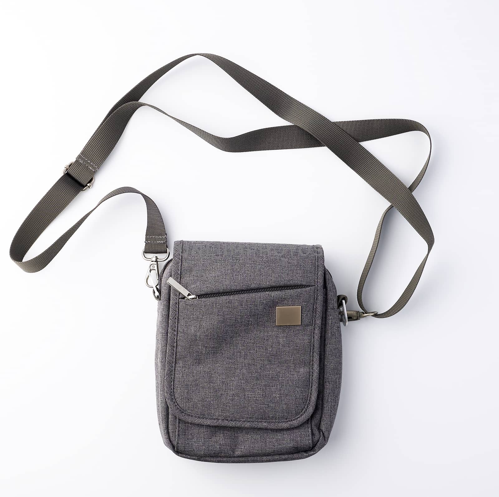 closed gray textile men's bag with a long strap on a white background, top view