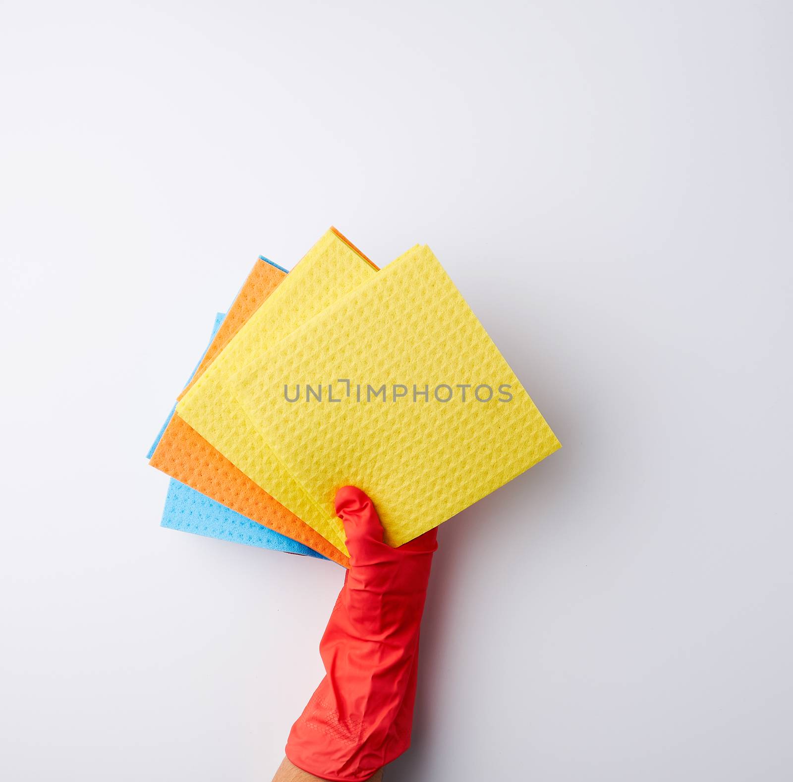 multi-colored square absorbent sponges in their hands wearing red rubber gloves, white background, top view, place for text
