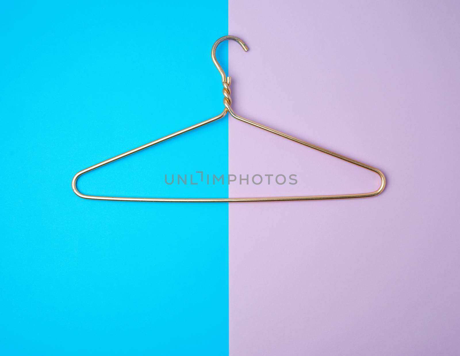 yellow metal hanger on a colored background, close up