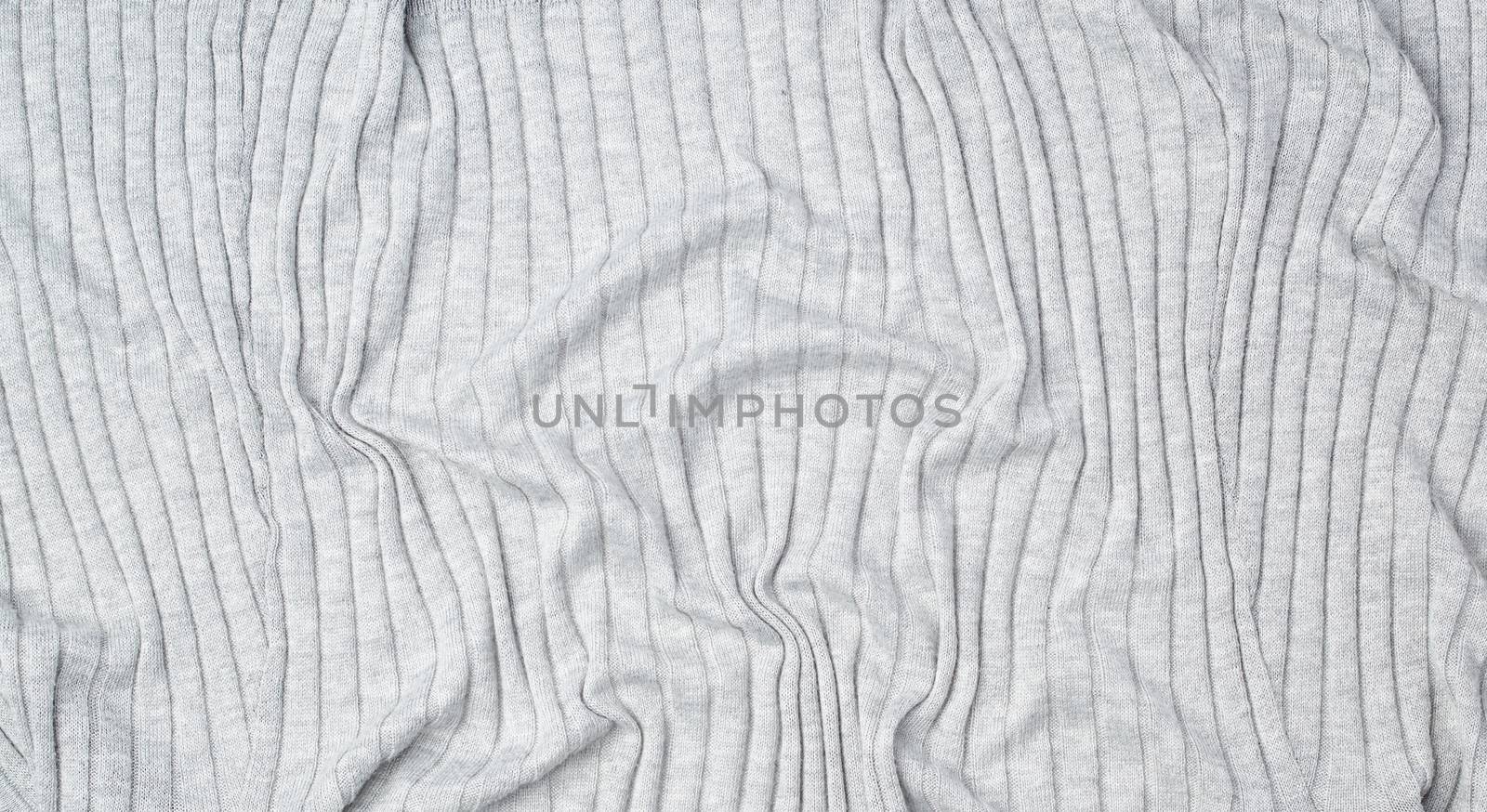 fragment of gray knitted fabric, full frame, fabric for sweaters, wavy surface