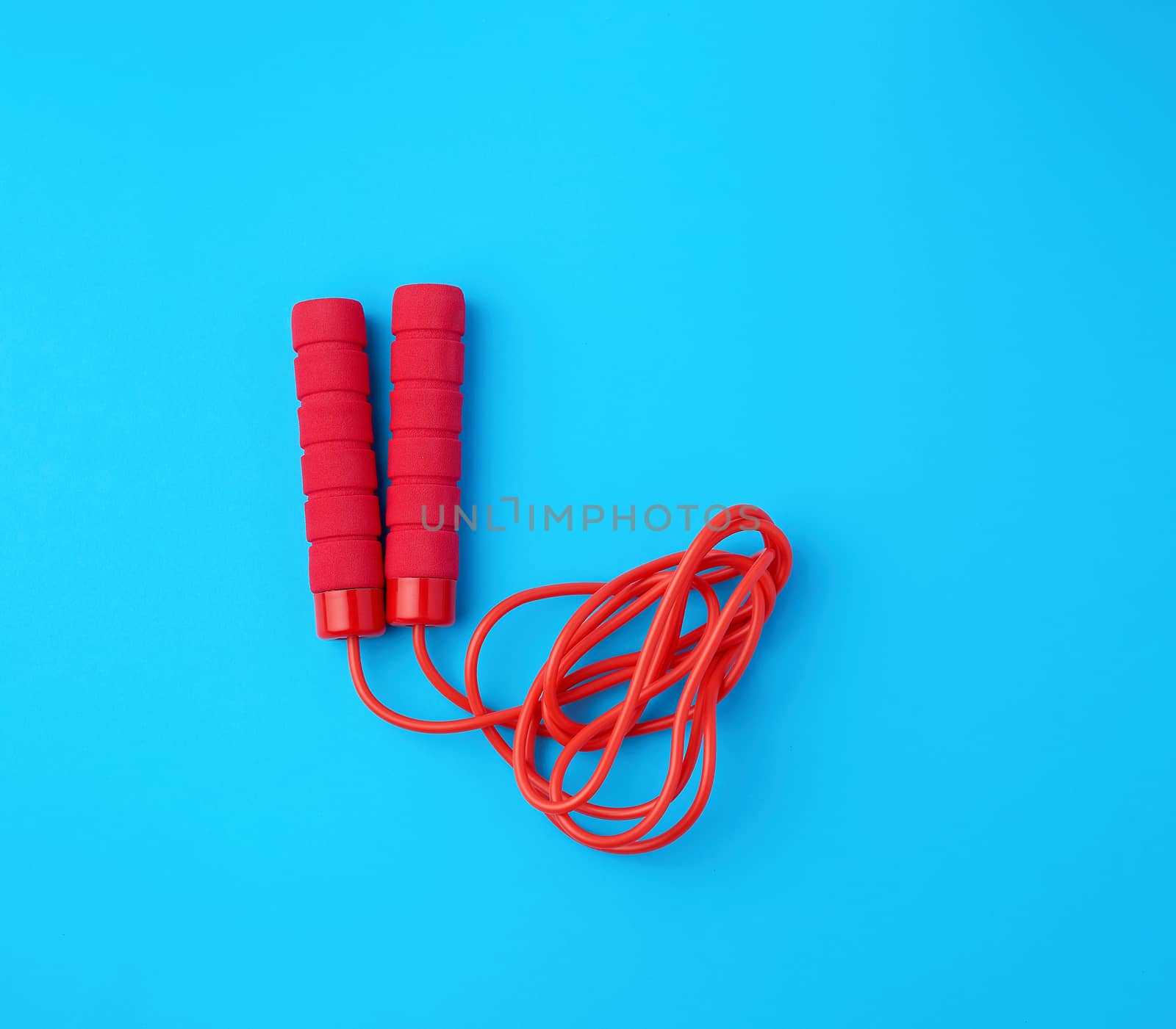 red rope for sports on a blue background, two neoprene handle